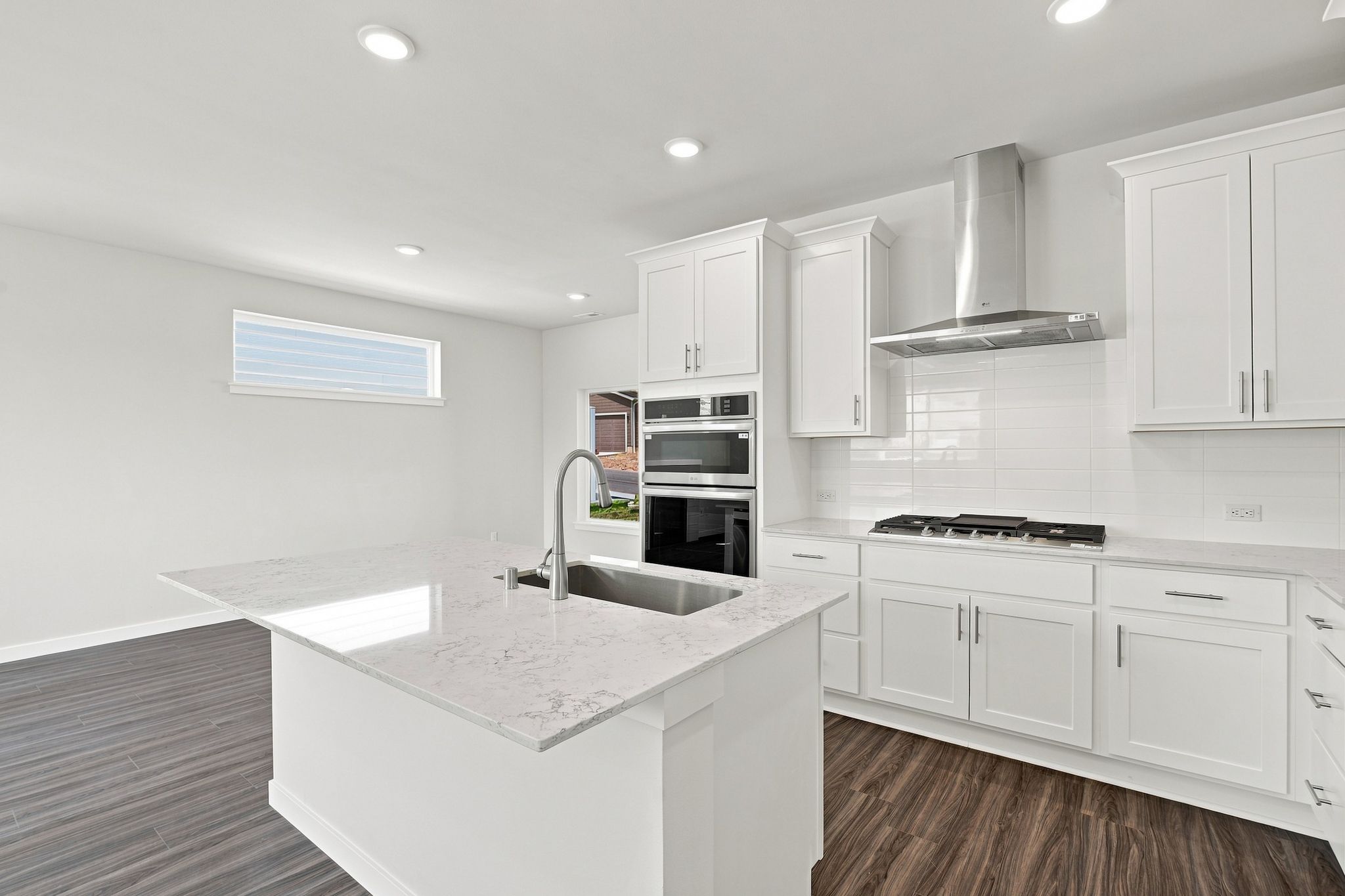 A kitchen with white cabinets.