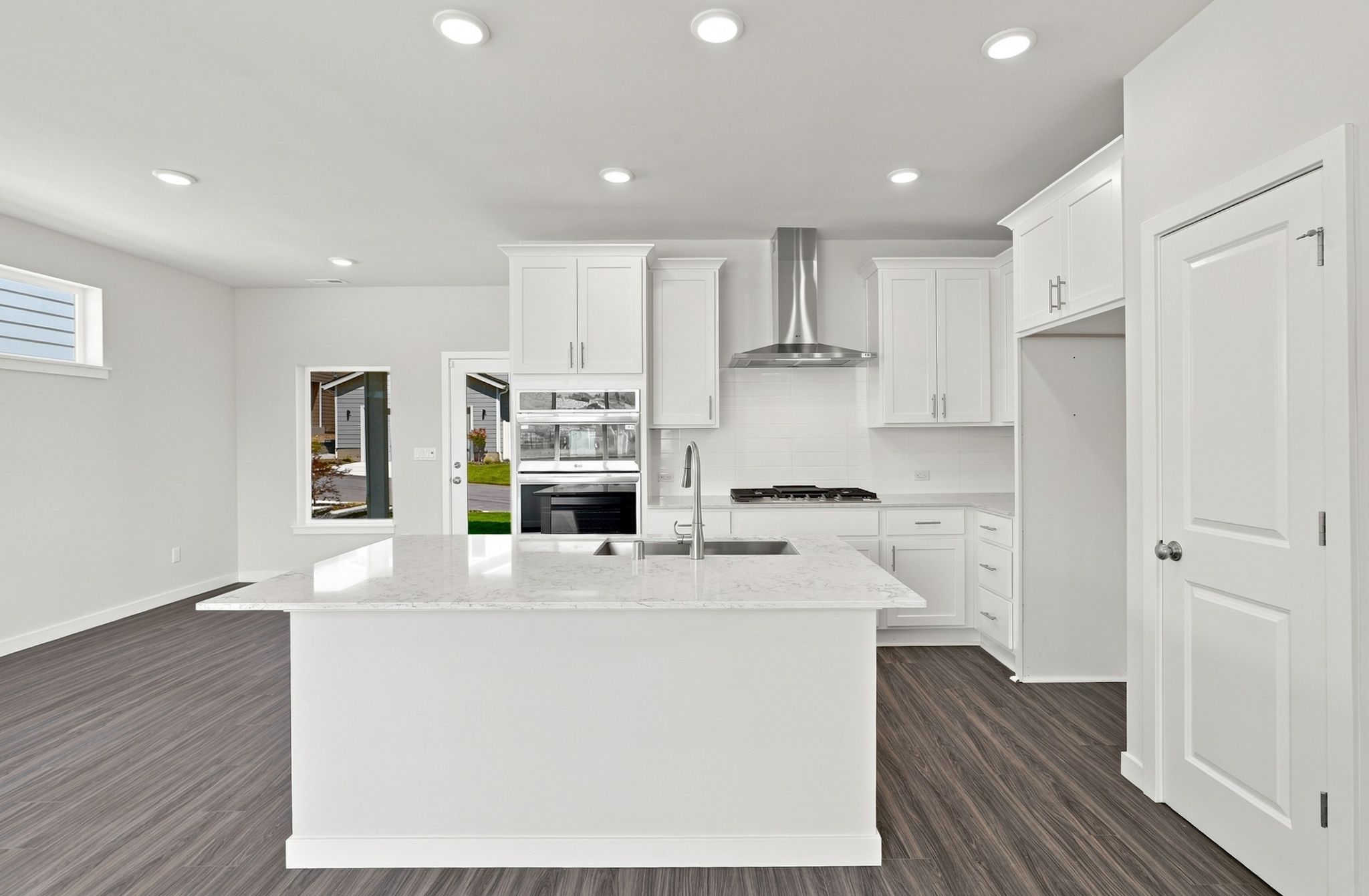 A kitchen with white cabinets.
