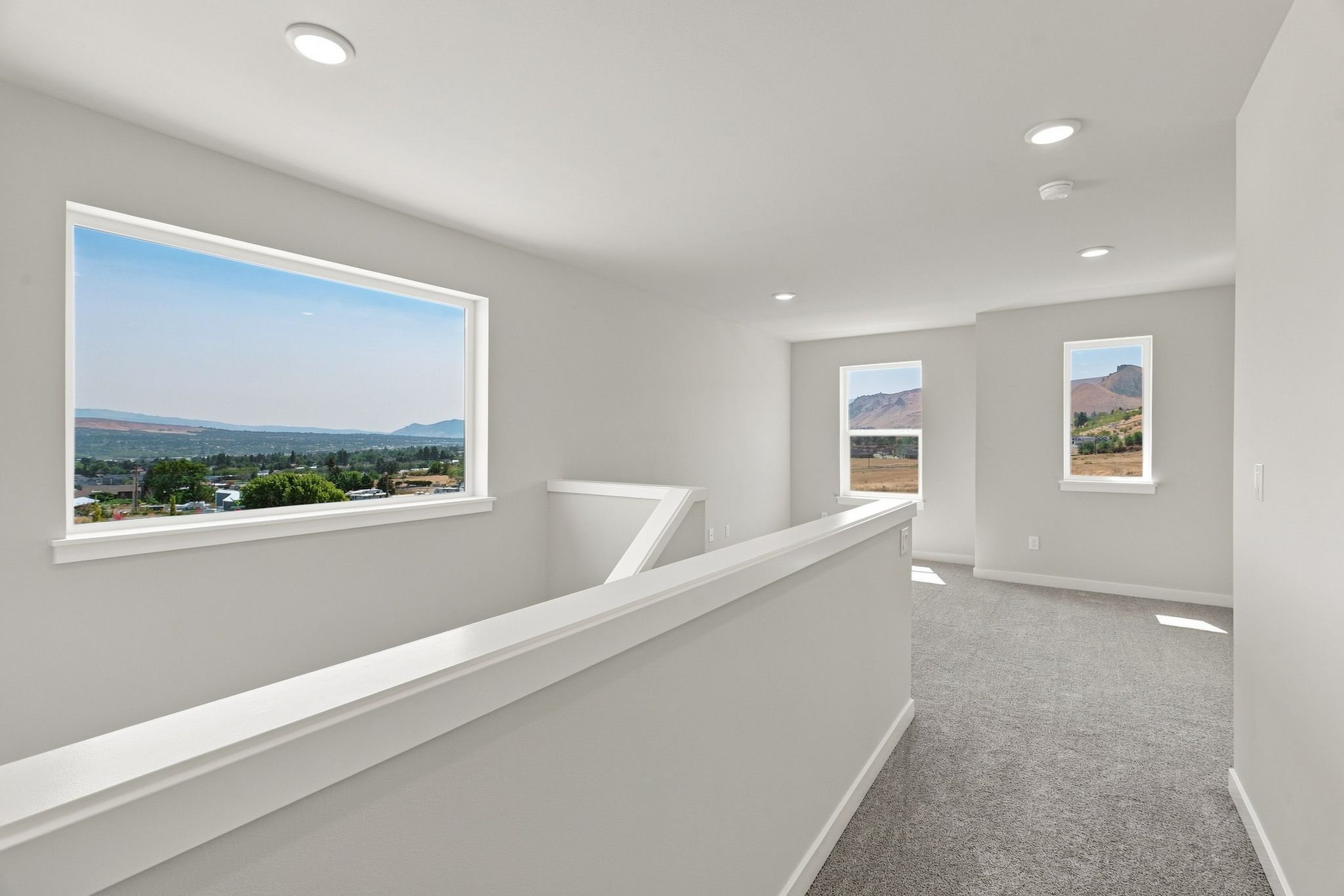 A white room with a large window.