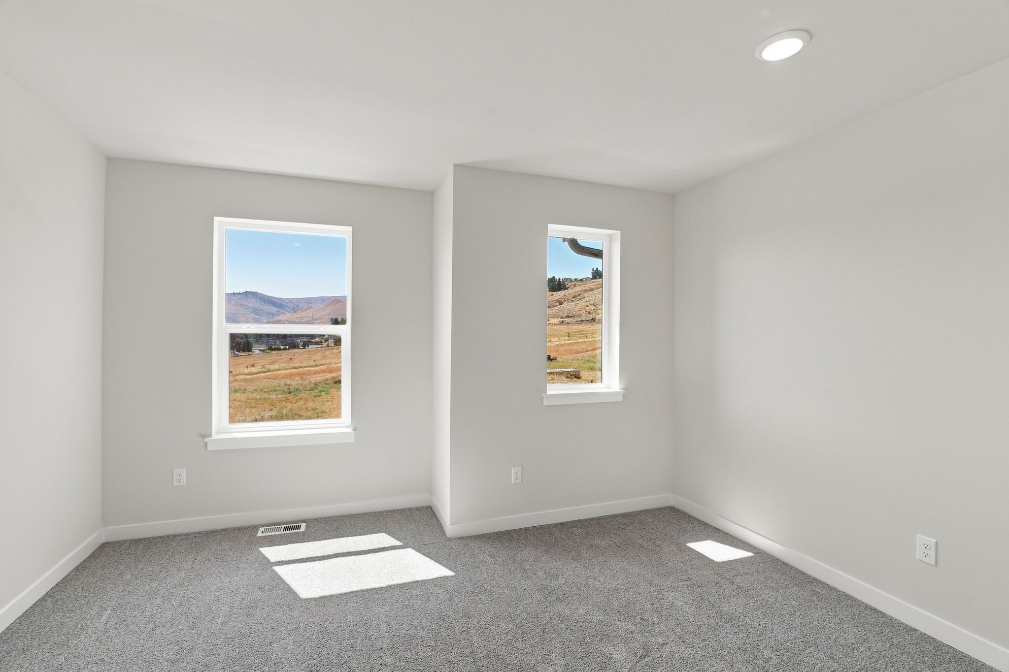 A room with a few paintings on the wall.