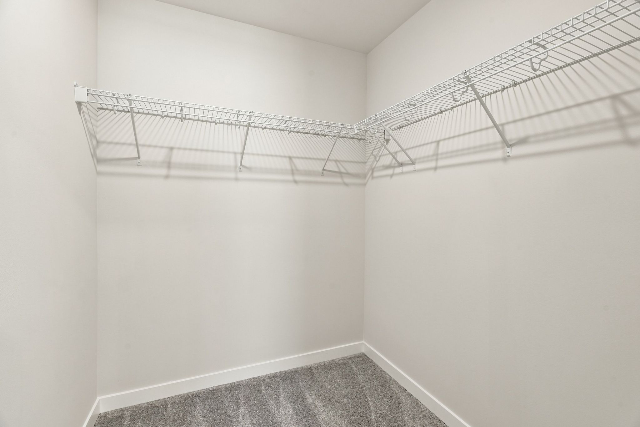 A white room with a metal railing.