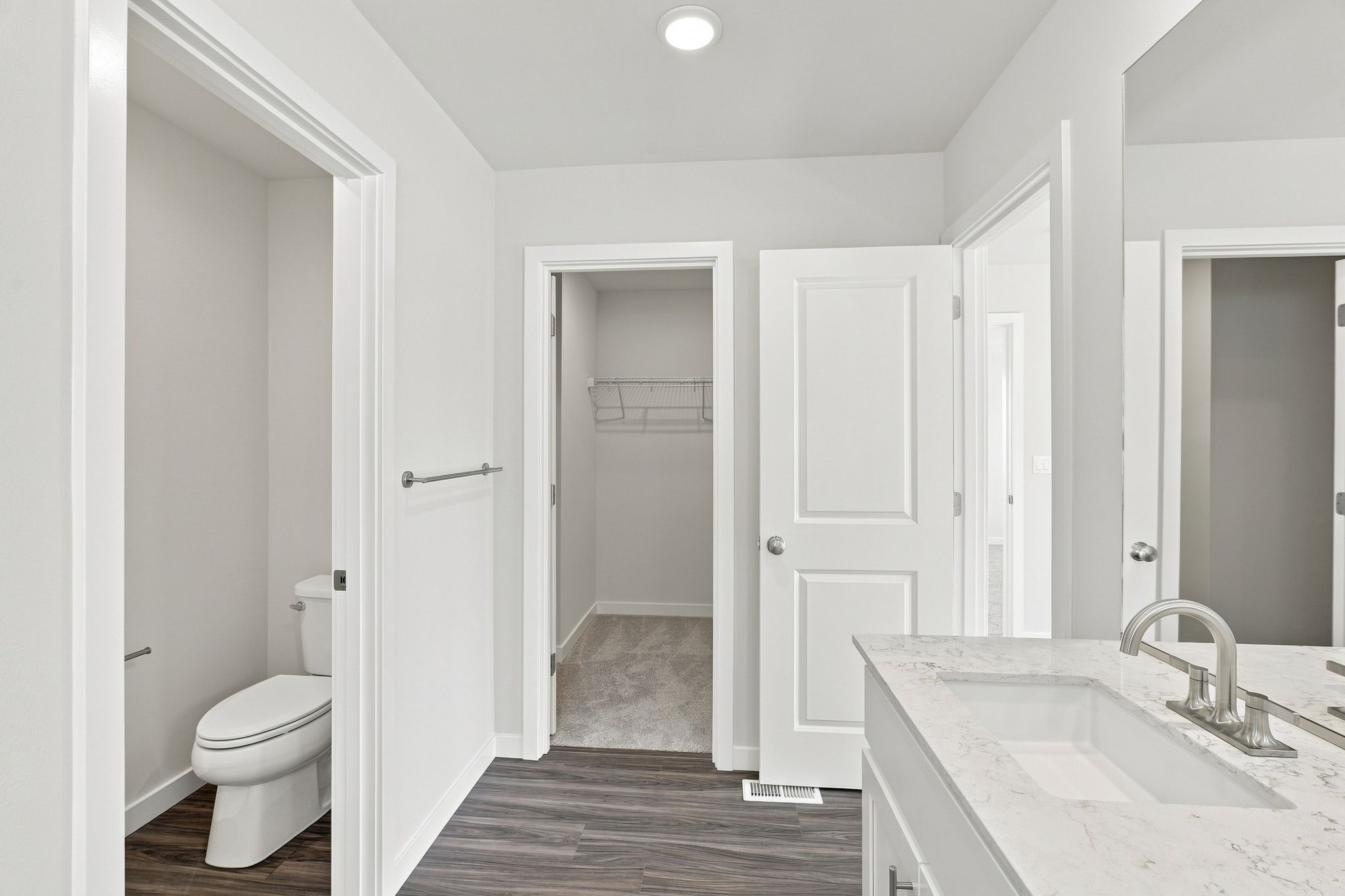 A bathroom with a tub sink and toilet.