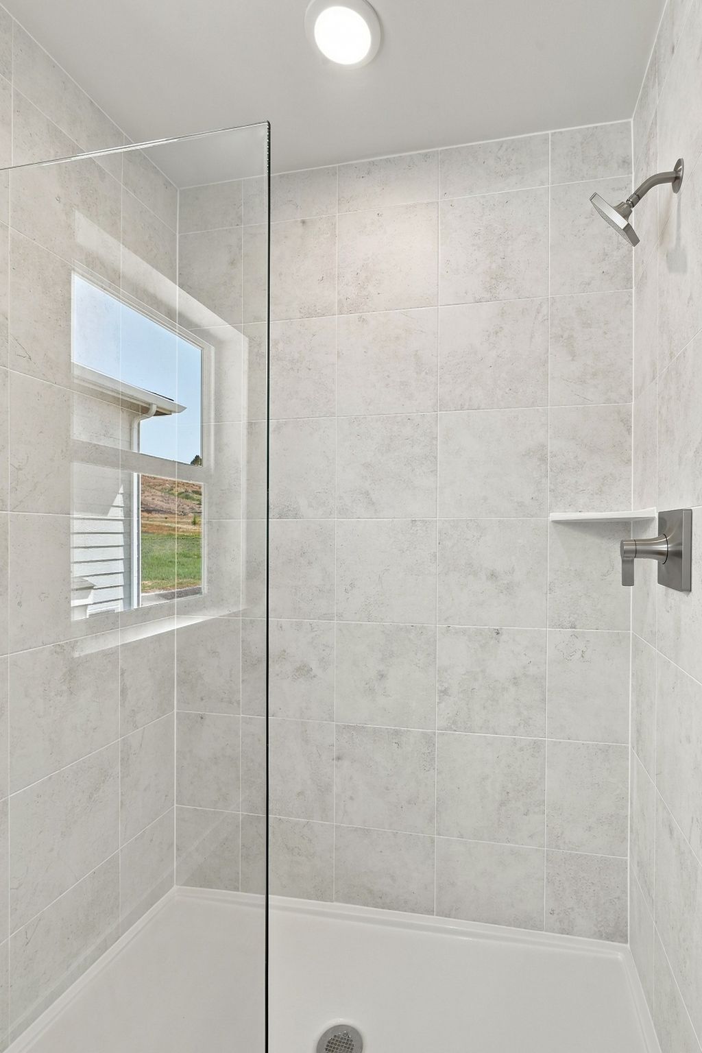 A shower with a glass door.
