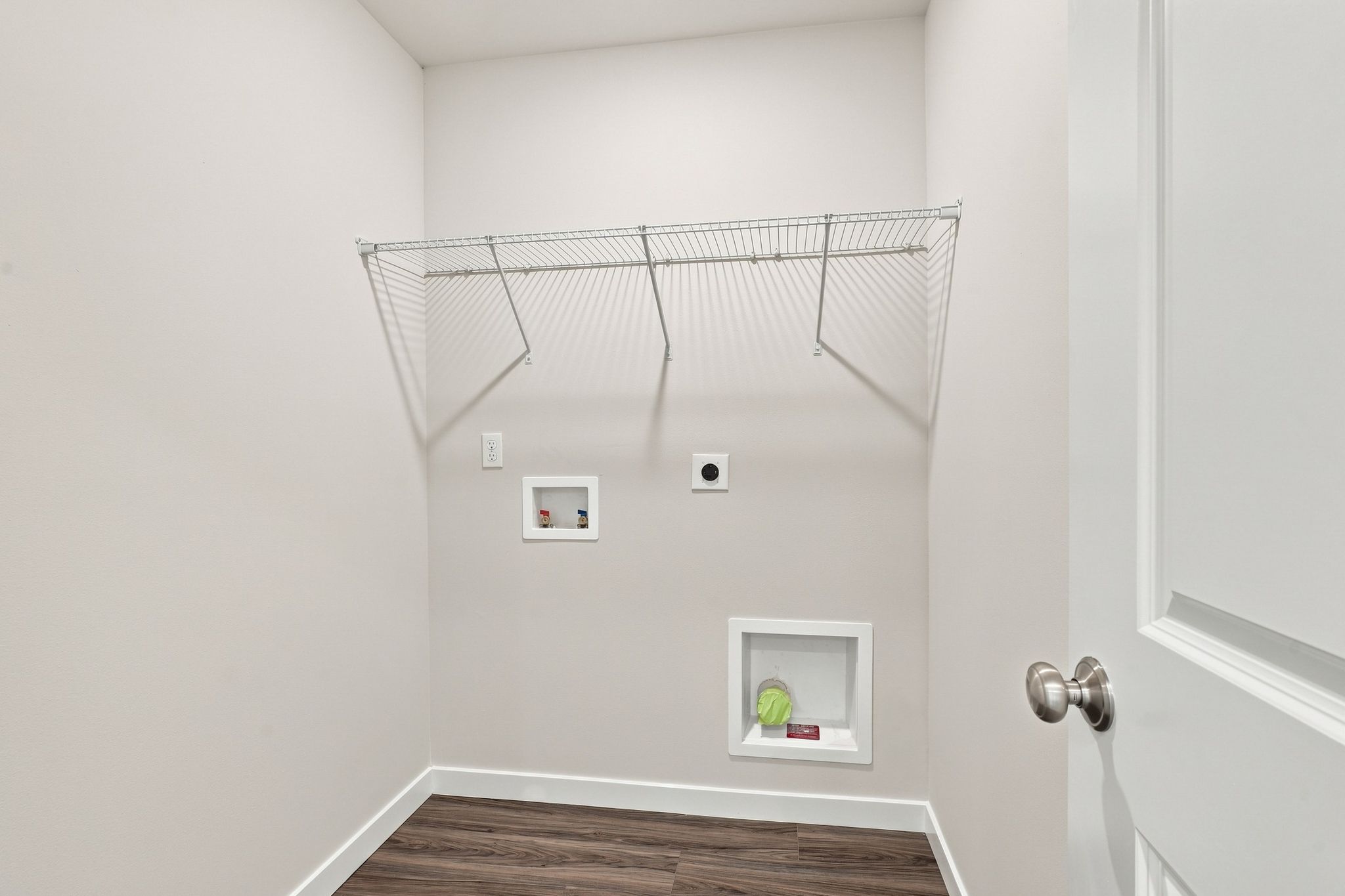 A white room with a metal rack.