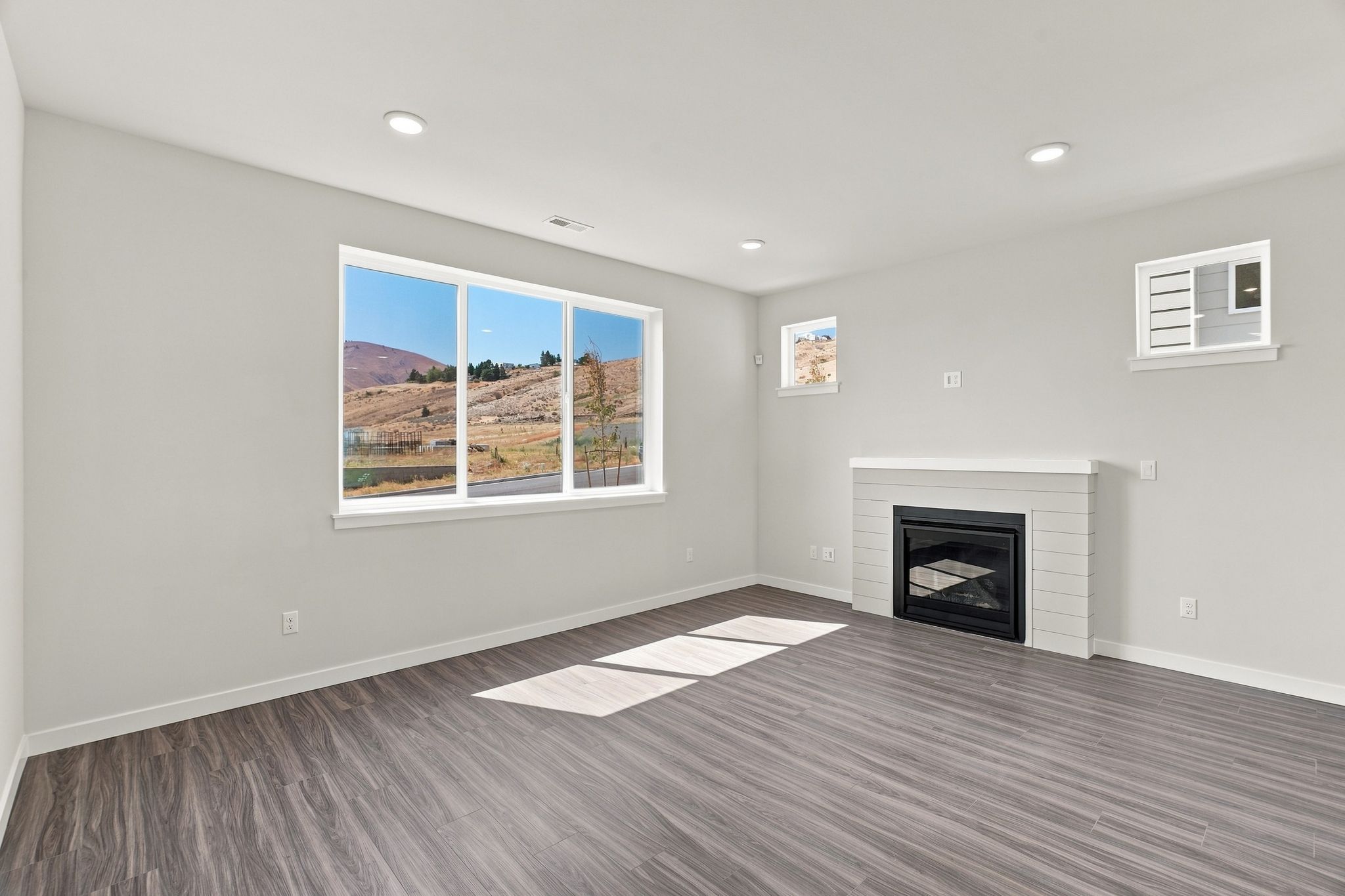 A room with a fireplace and a window.