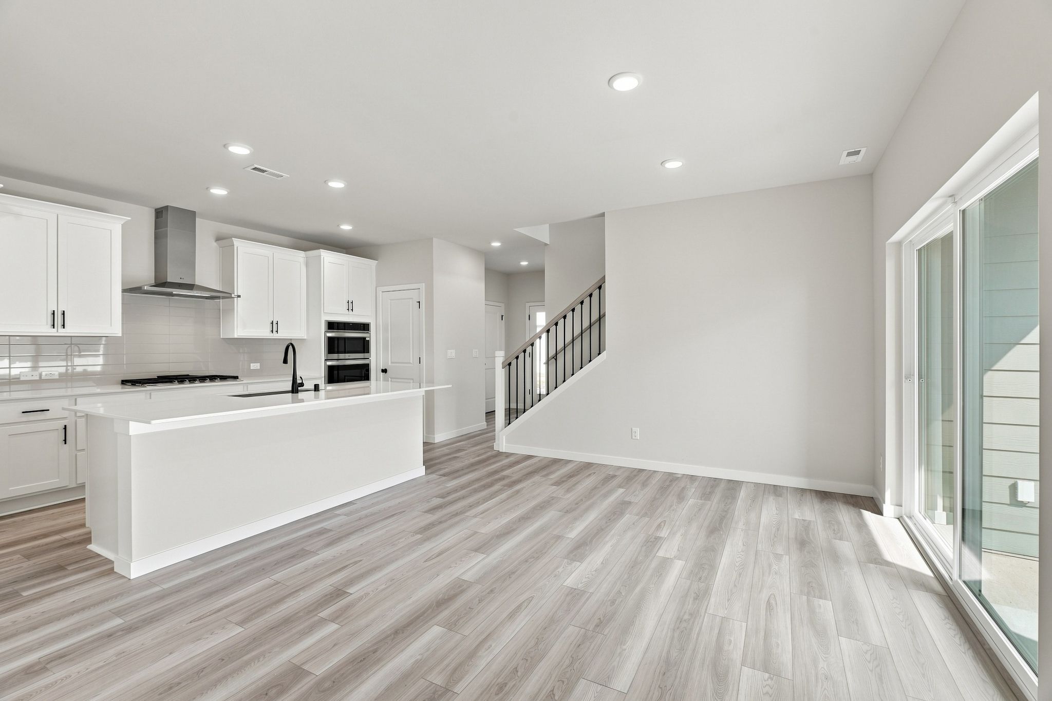 A kitchen with white cabinets.