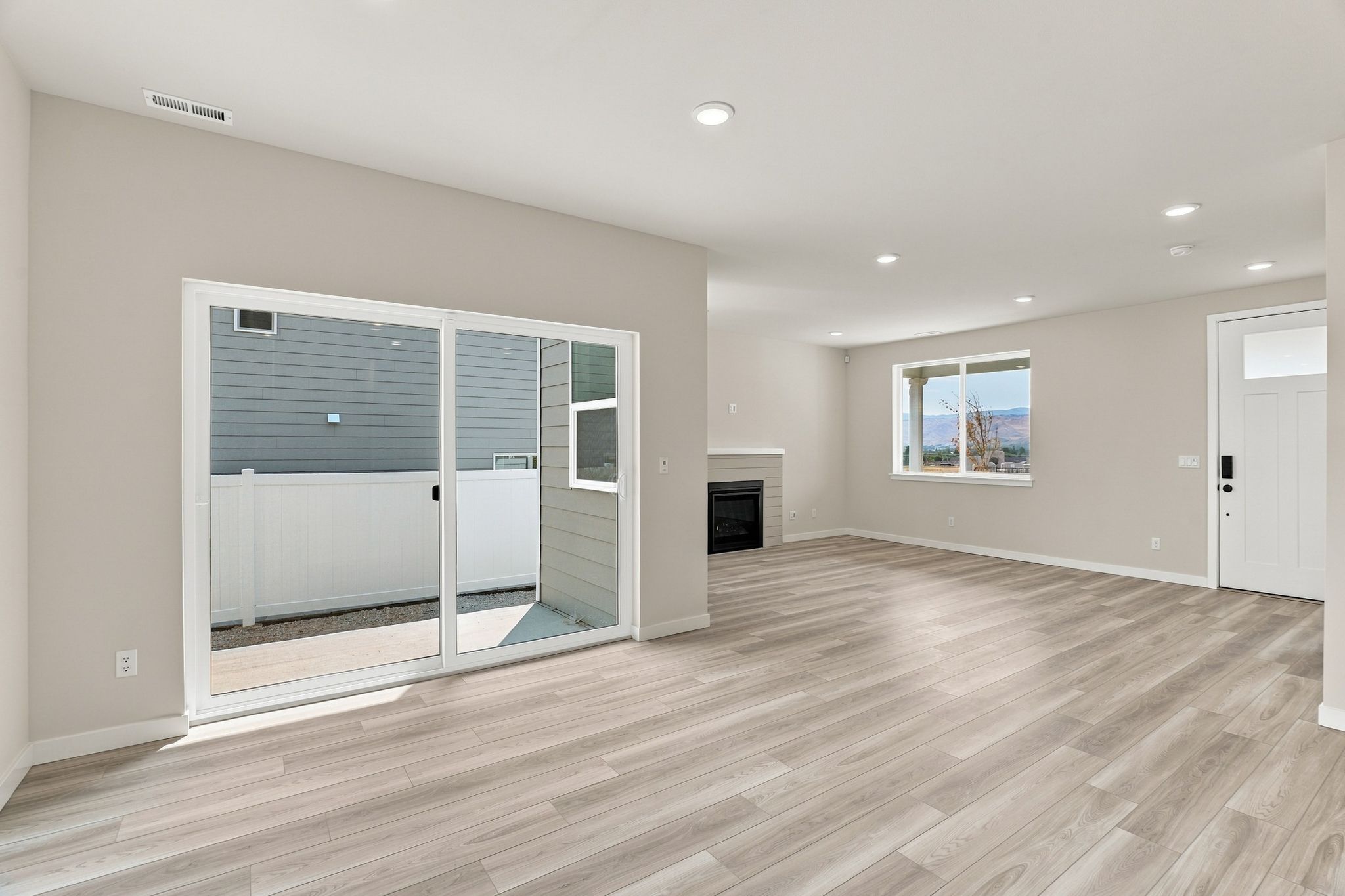 A room with a wood floor and white walls.