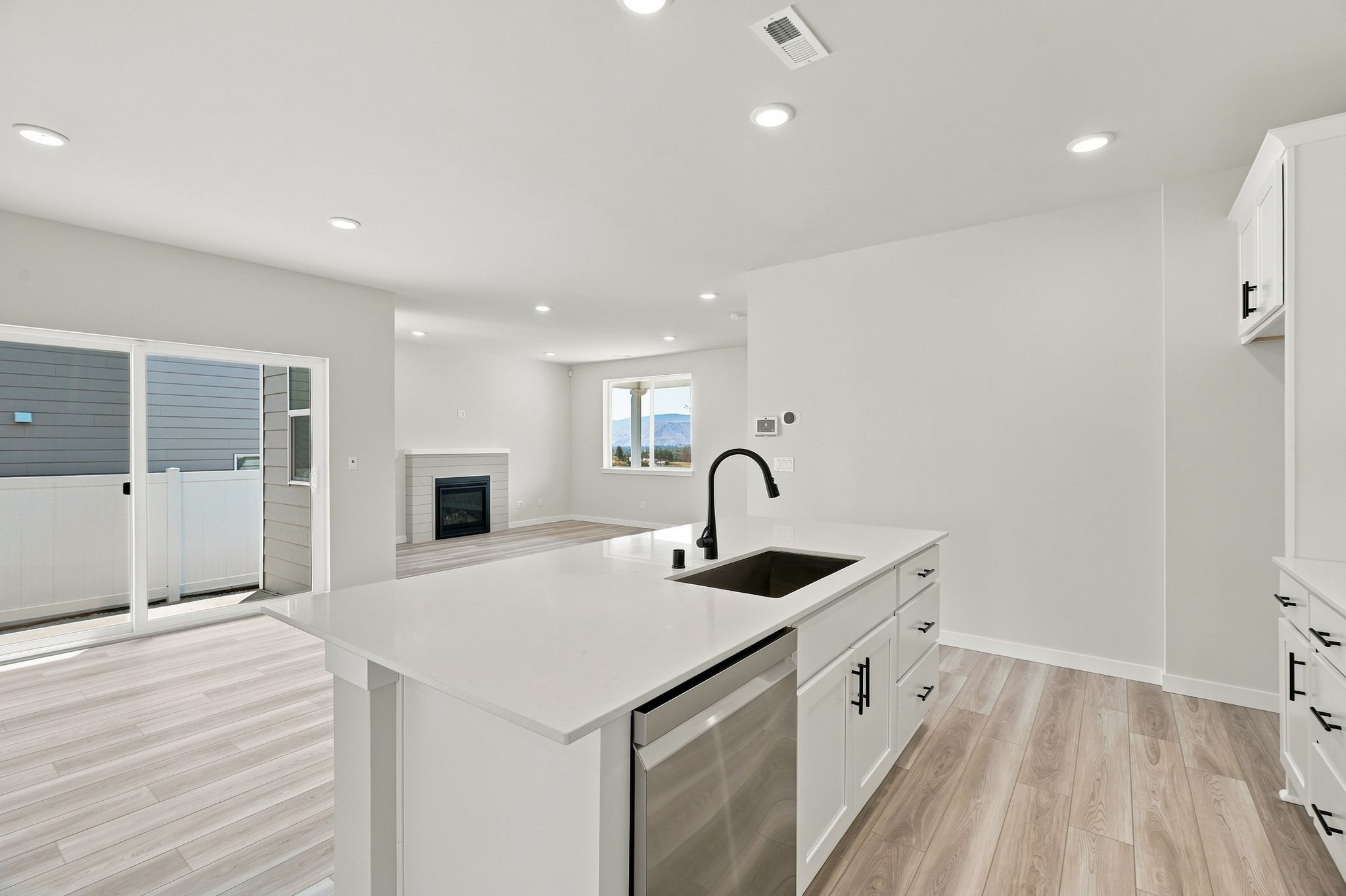 A kitchen with white cabinets.