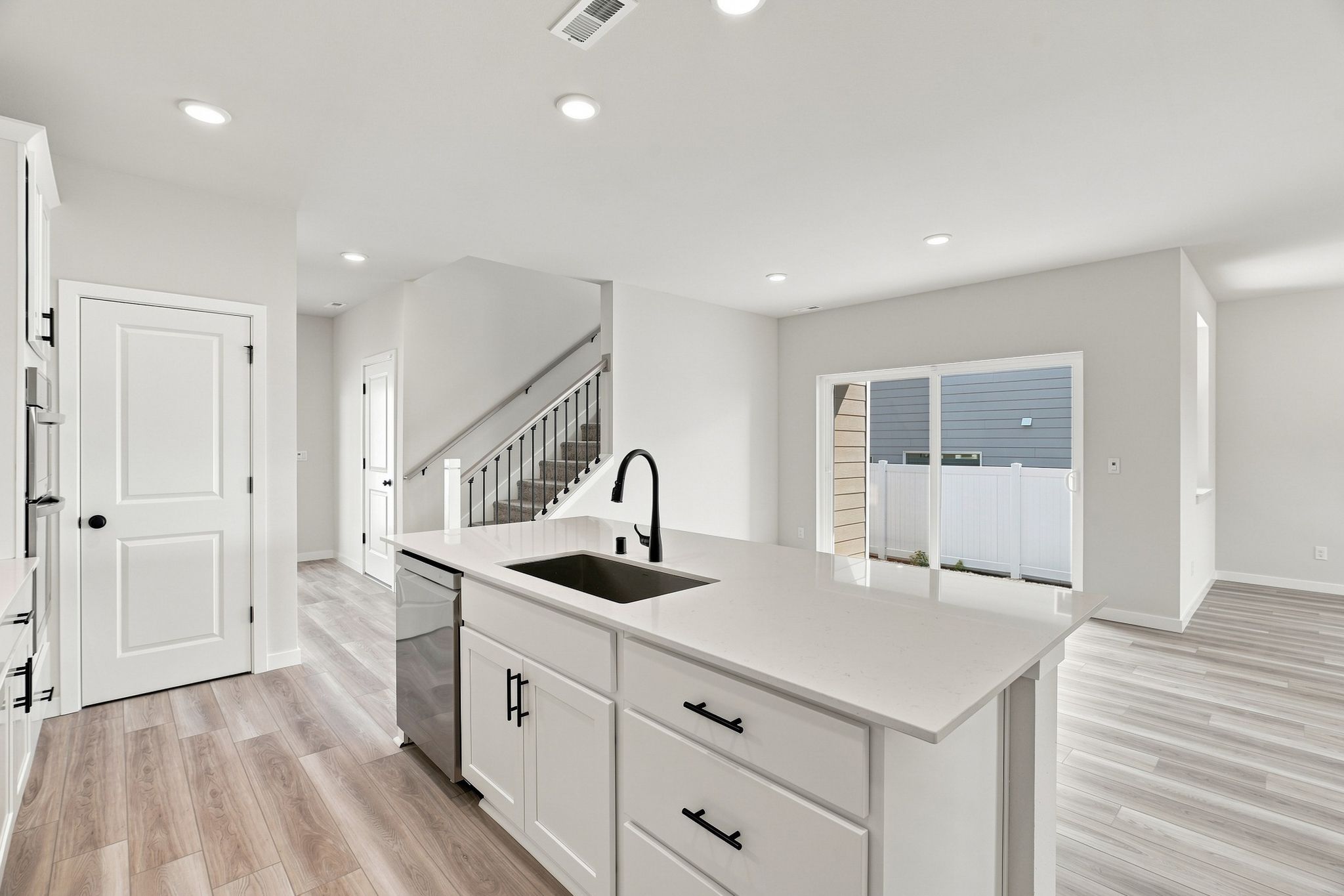 A kitchen with white cabinets.