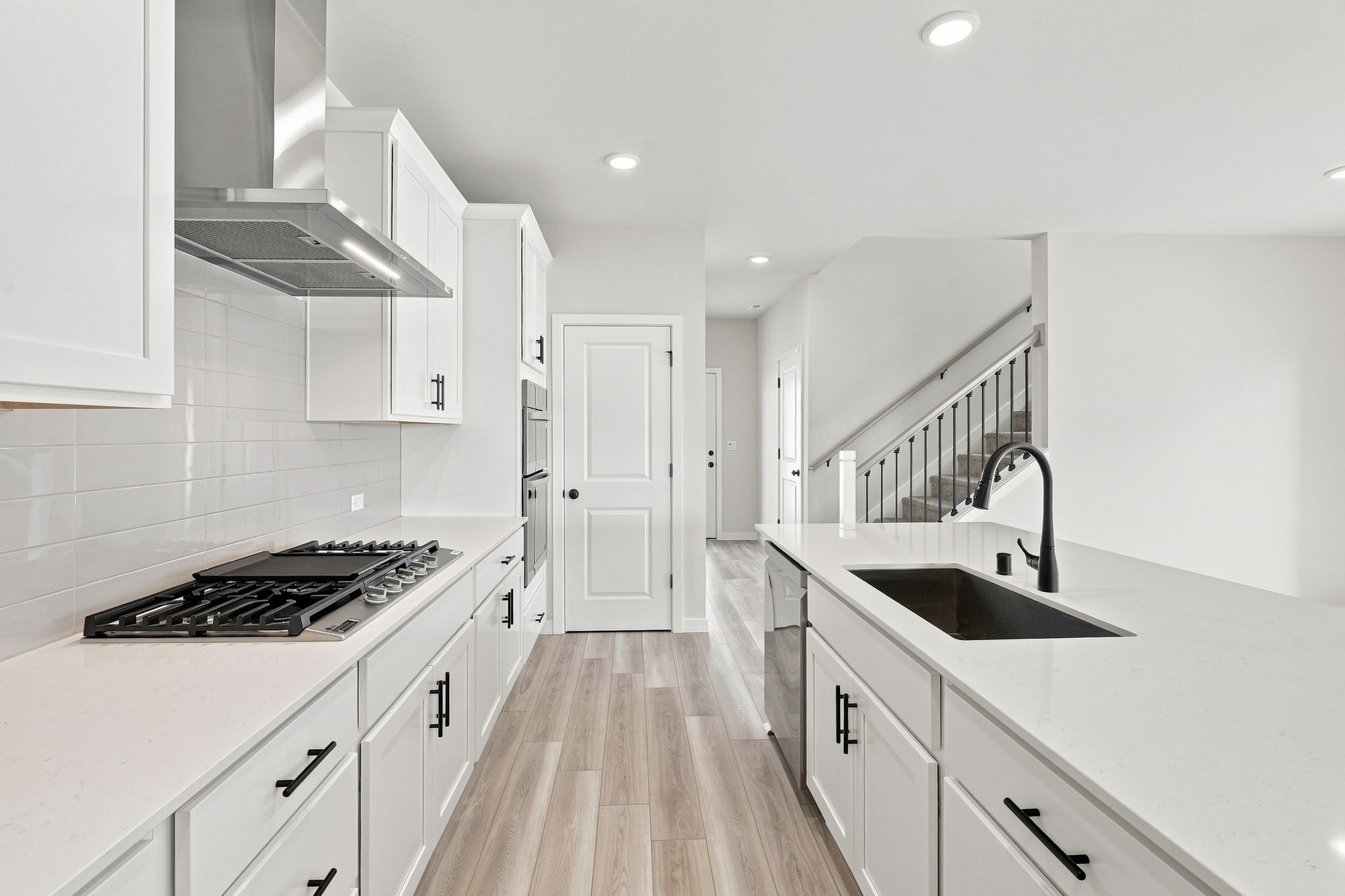 A kitchen with white cabinets.