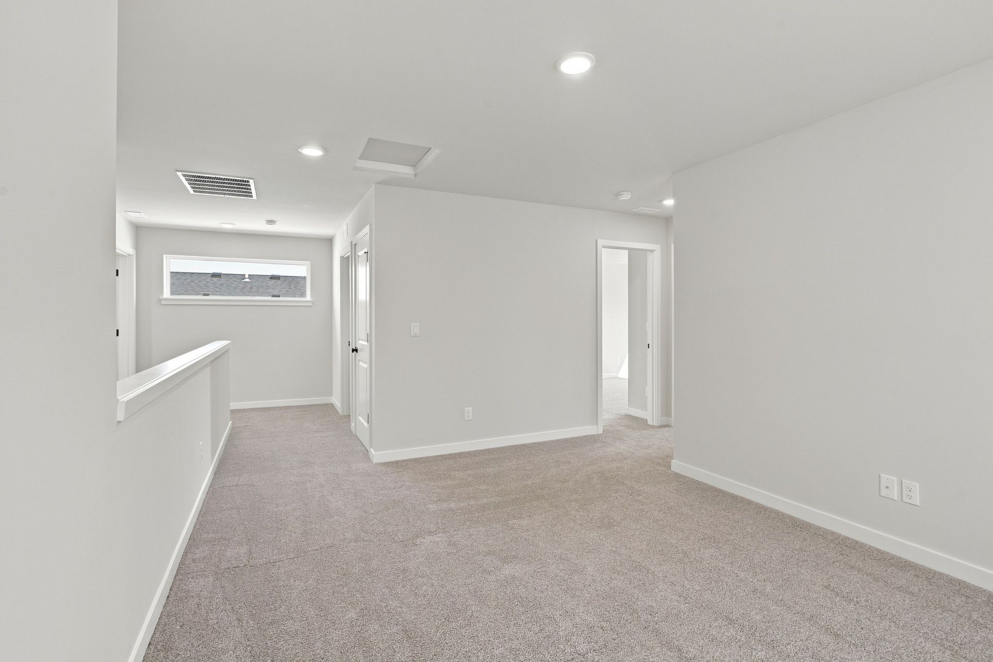 A hallway with white walls.