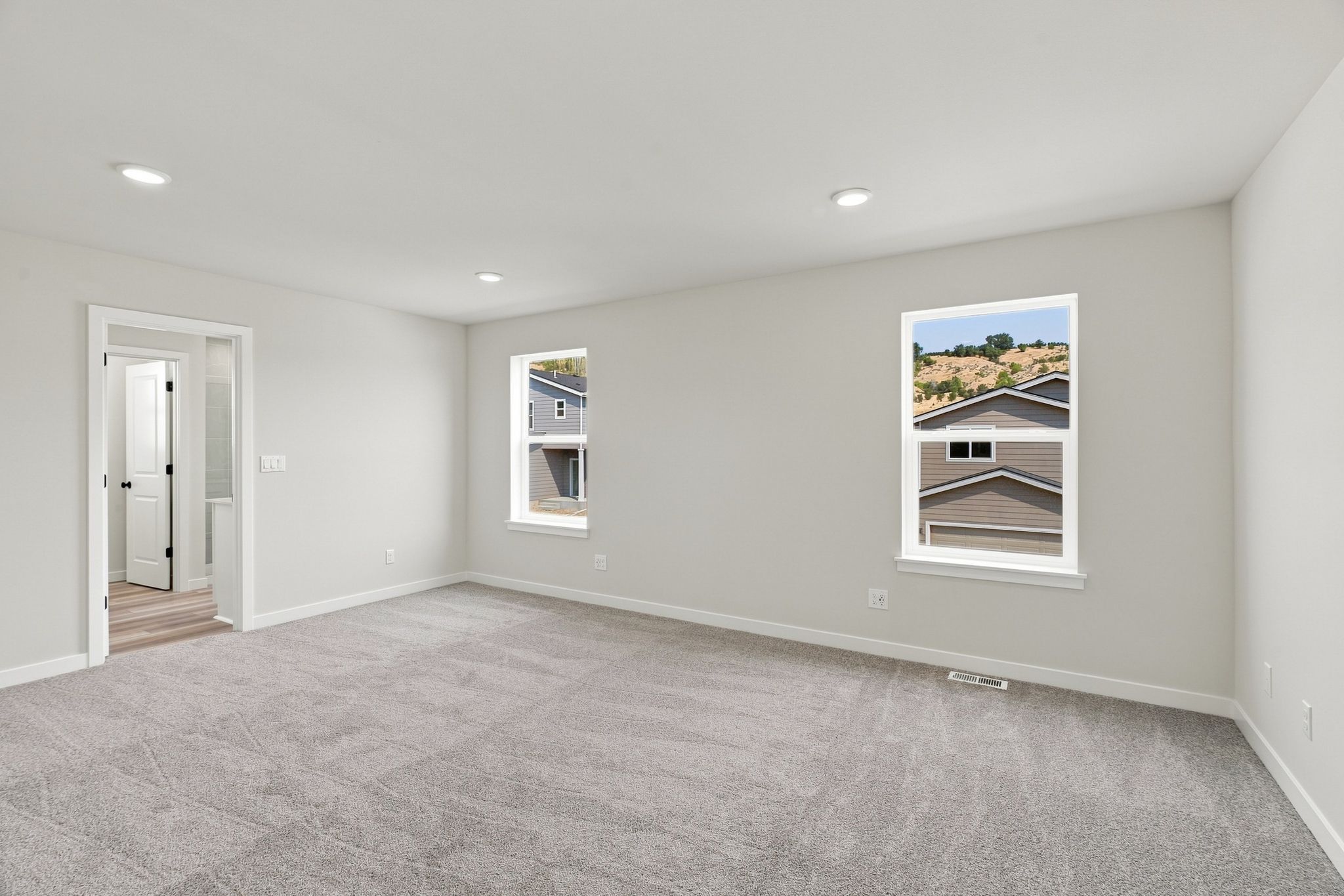 A room with a carpet and a painting on the wall.