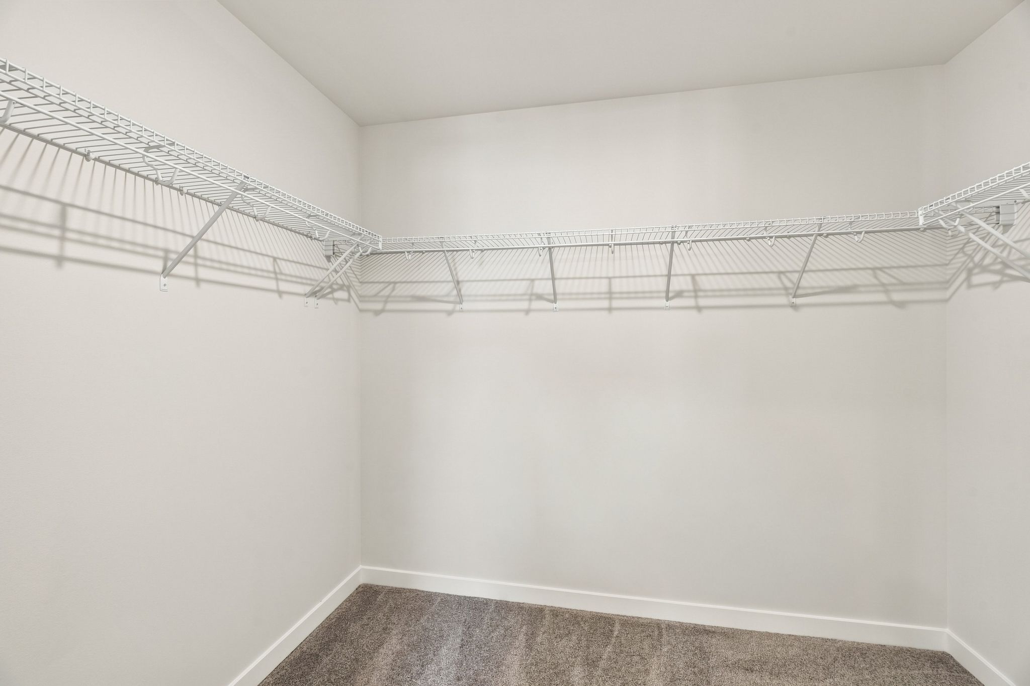 A white wall with a metal railing.