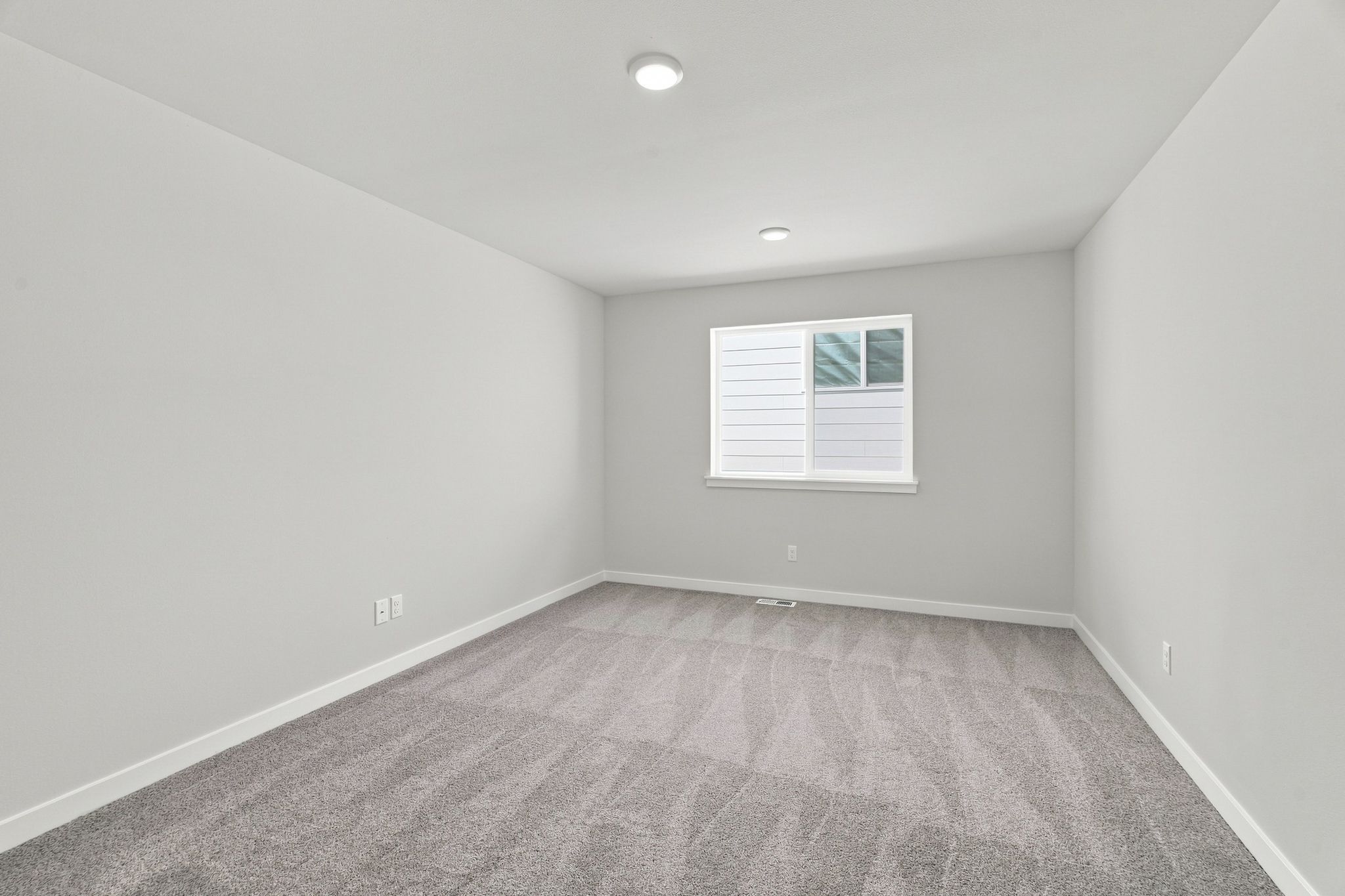 A room with a carpet and a rug.