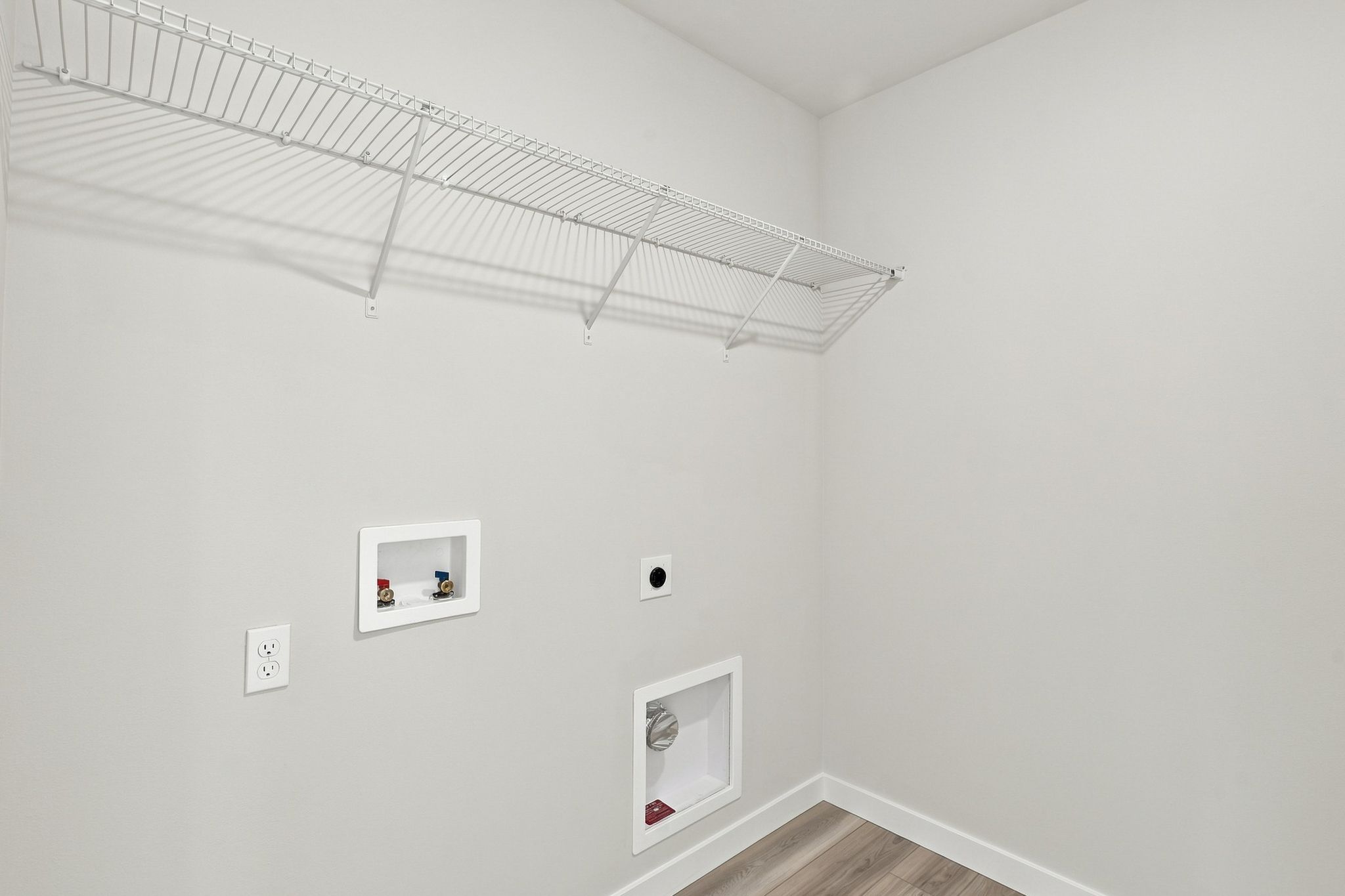 A white wall with a picture on it.