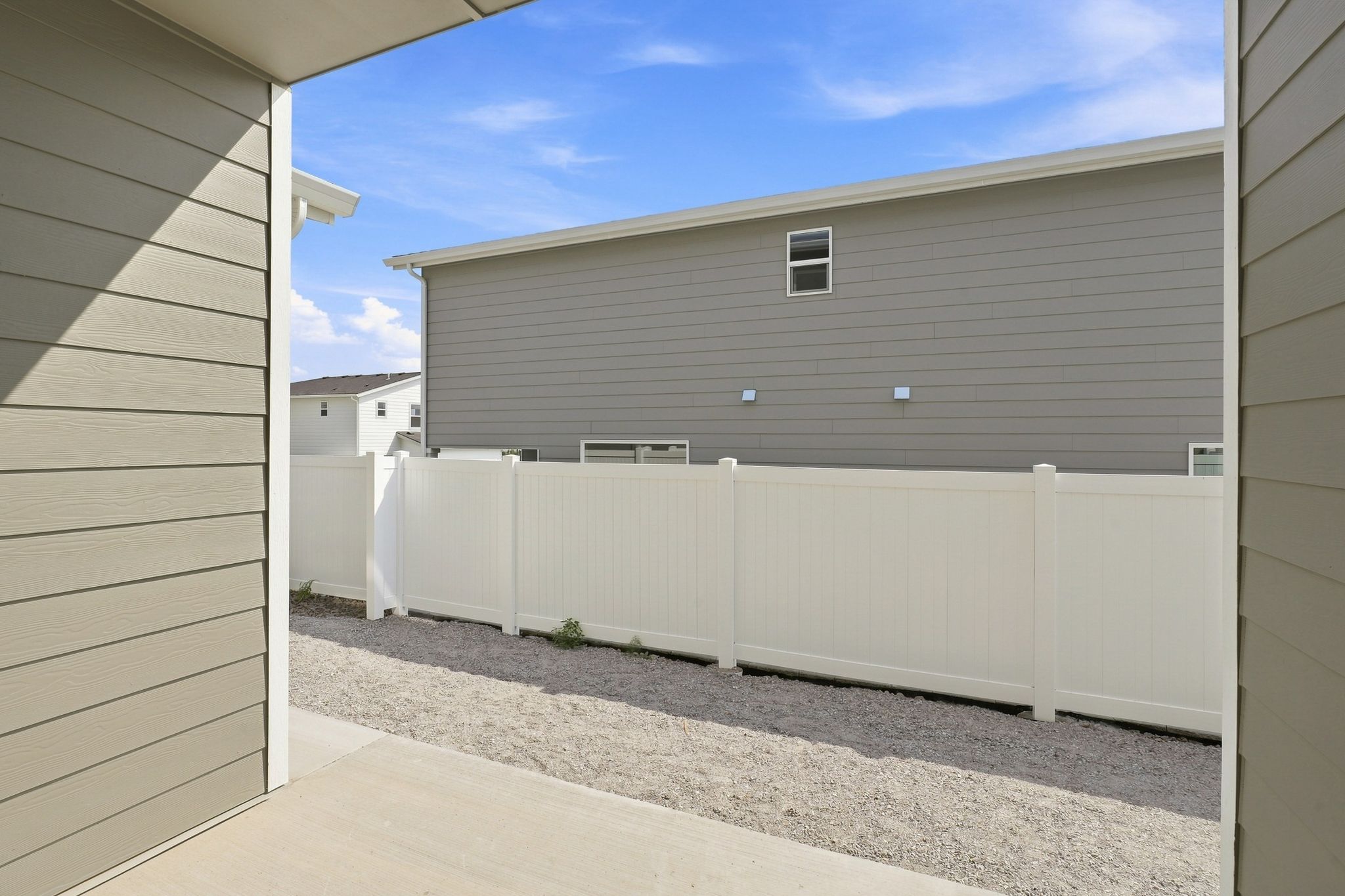 A white fence in front of a building.