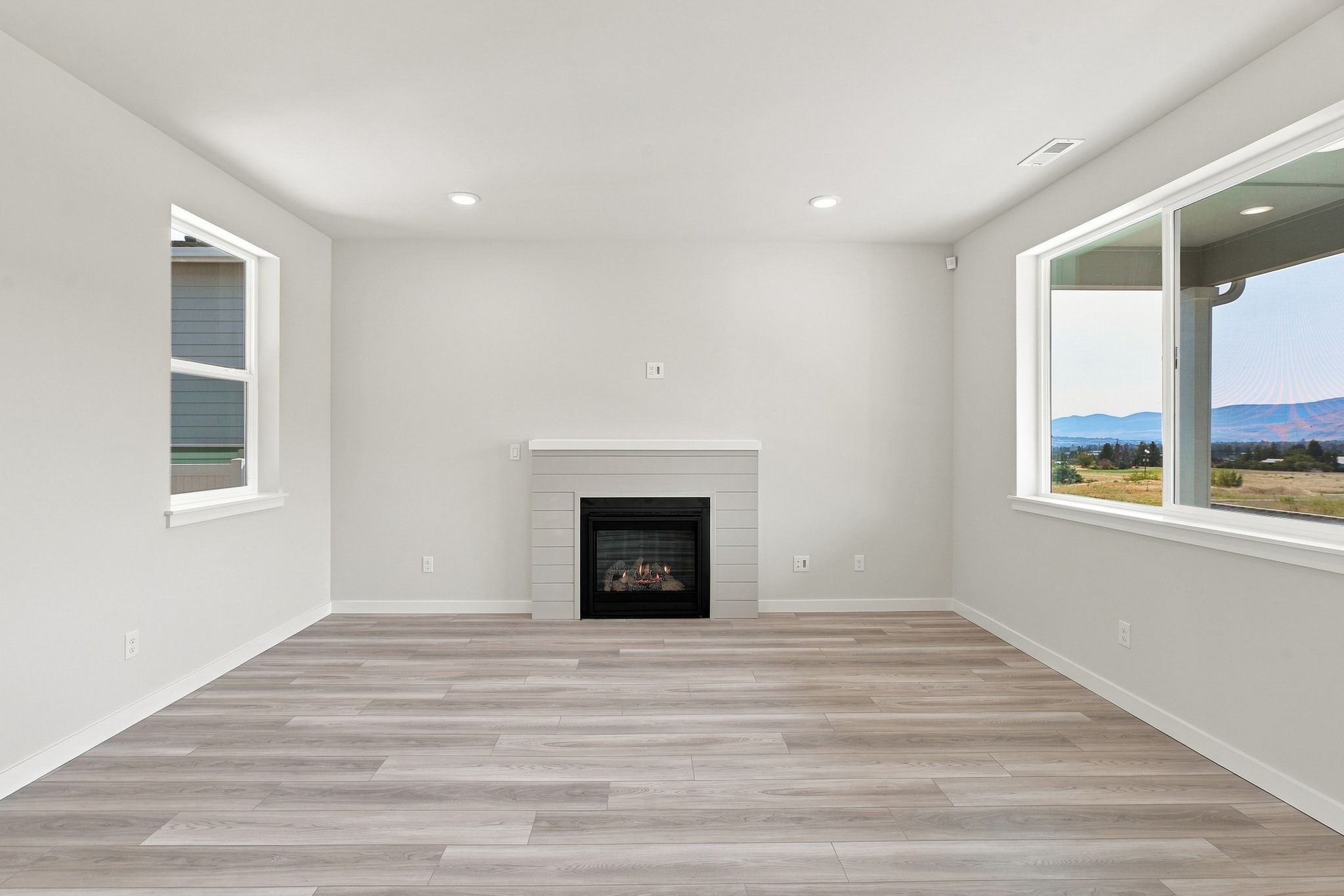 A room with a fireplace and a window.