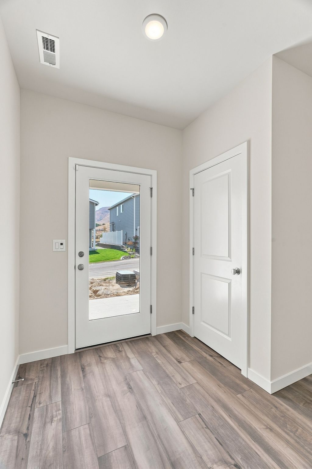 A room with a wood floor and white doors.