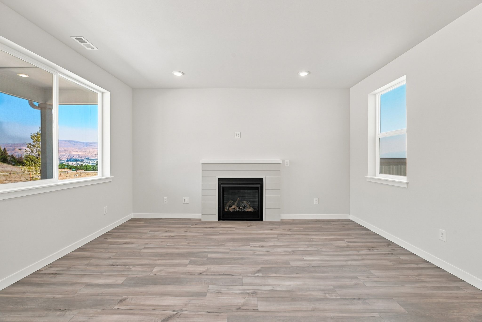 A room with a fireplace and windows.