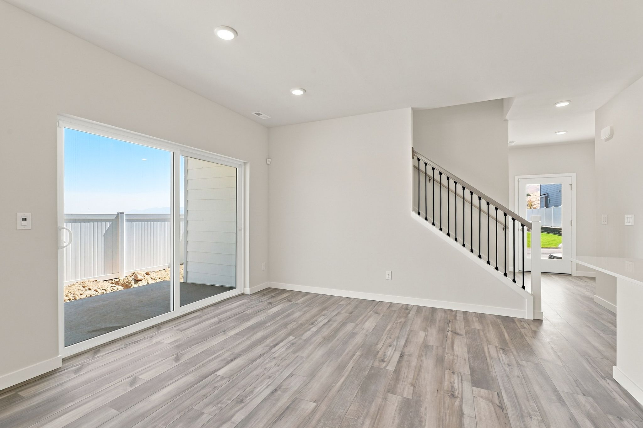 A room with a wood floor and a glass door.