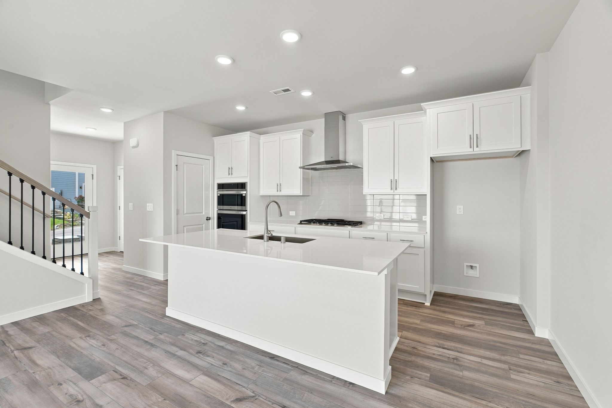 A kitchen with white cabinets.