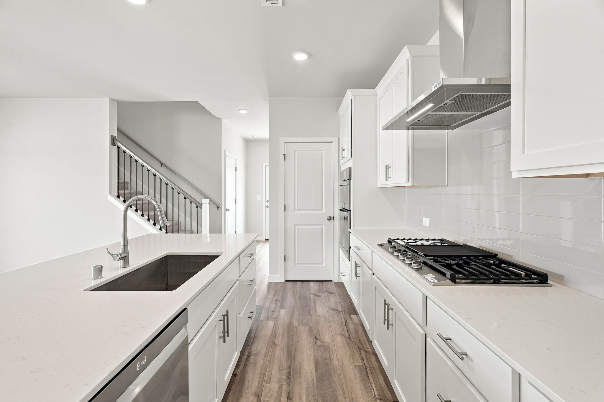 A kitchen with white cabinets.