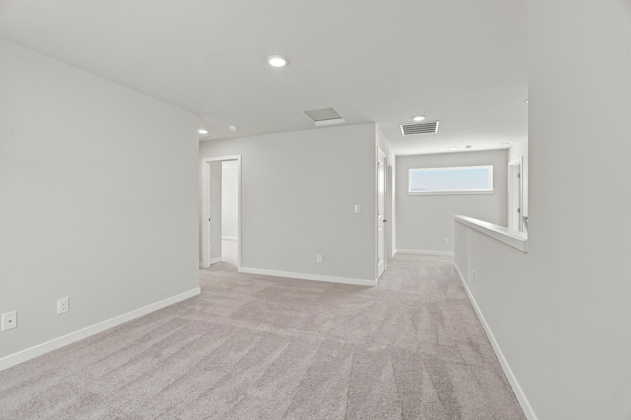 A hallway with white walls.