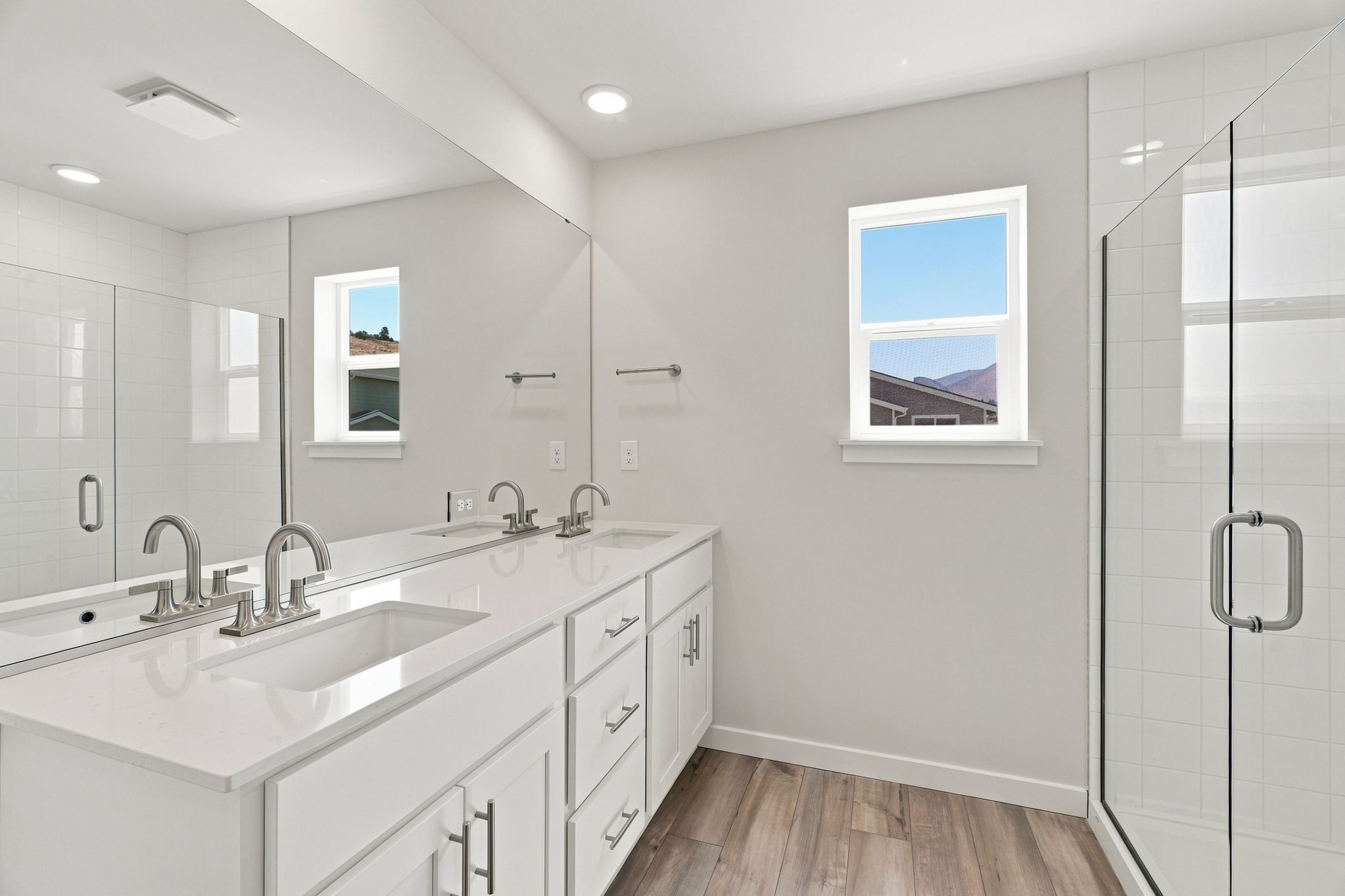 A bathroom with a large mirror.