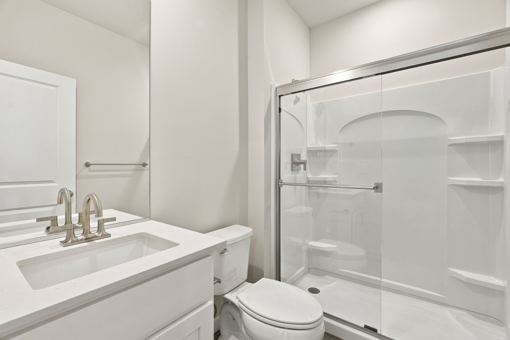 A bathroom with a glass shower.