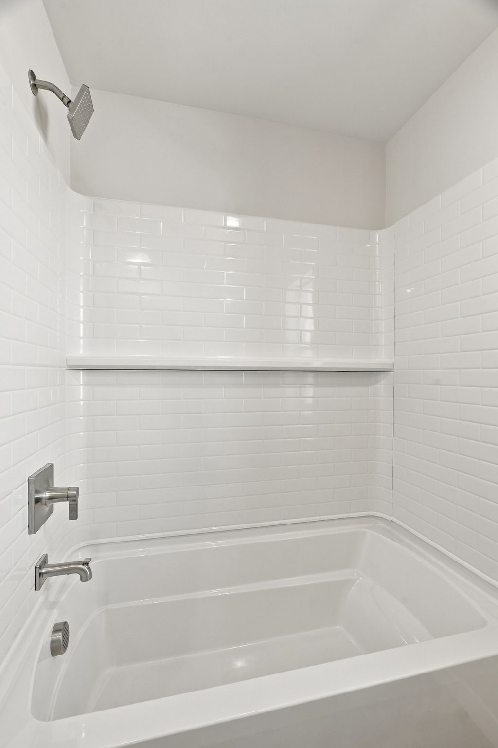 A bathtub in a bathroom.