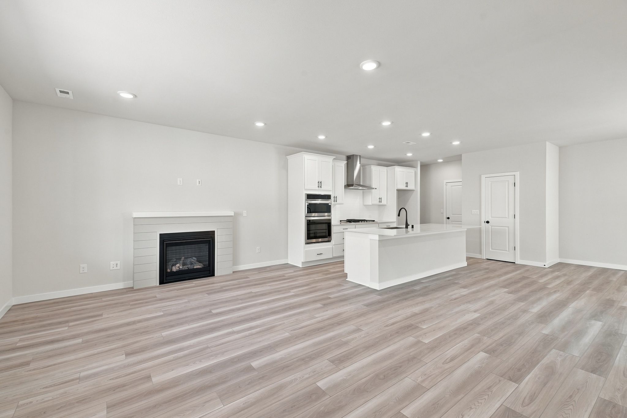 A large kitchen with a fireplace.