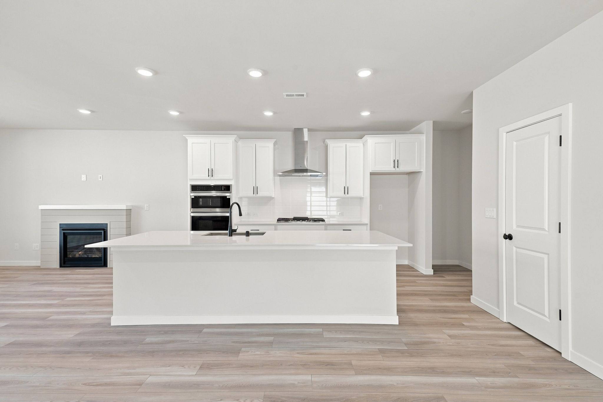 A large kitchen with white cabinets.