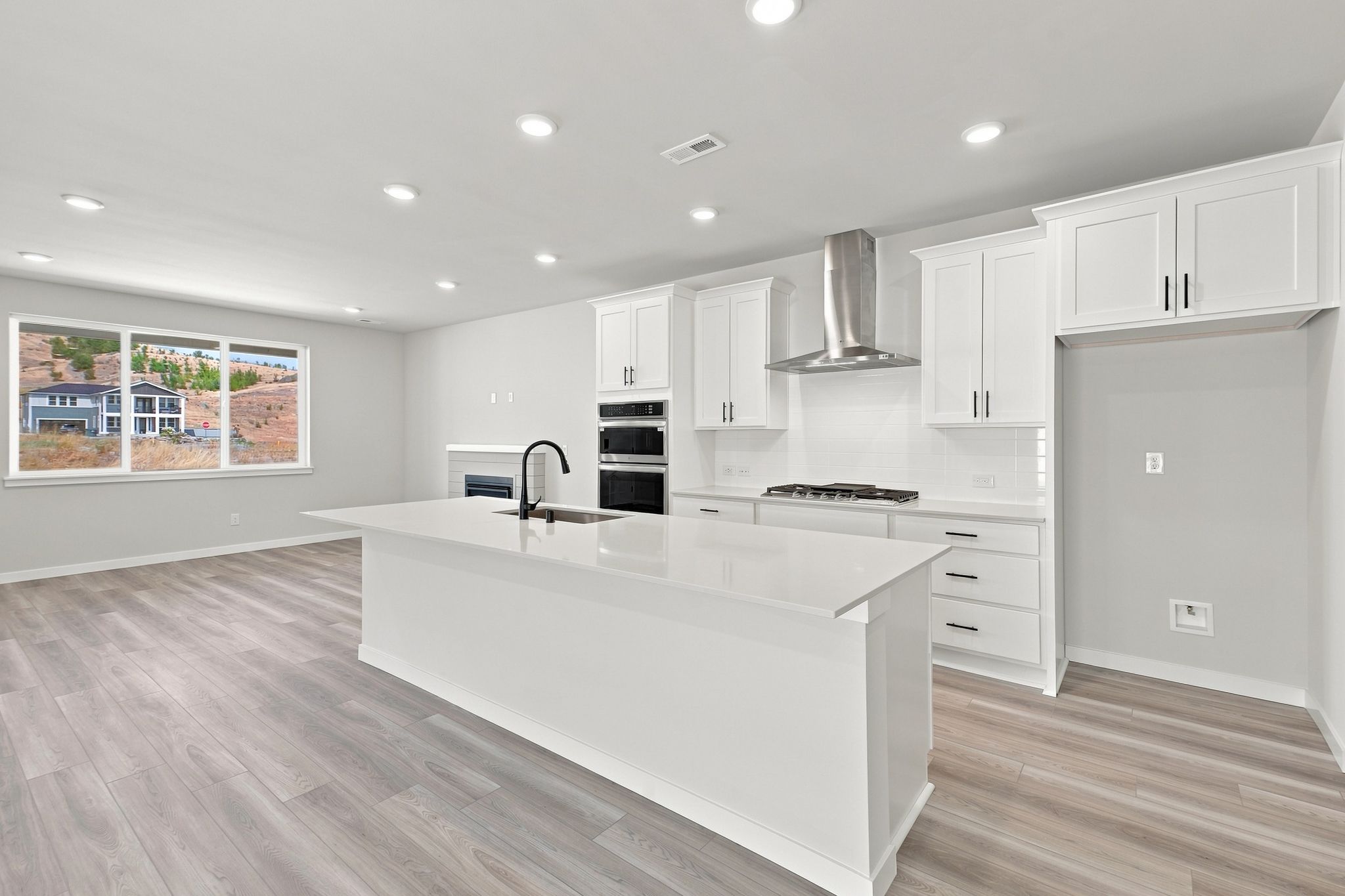 A kitchen with white cabinets.