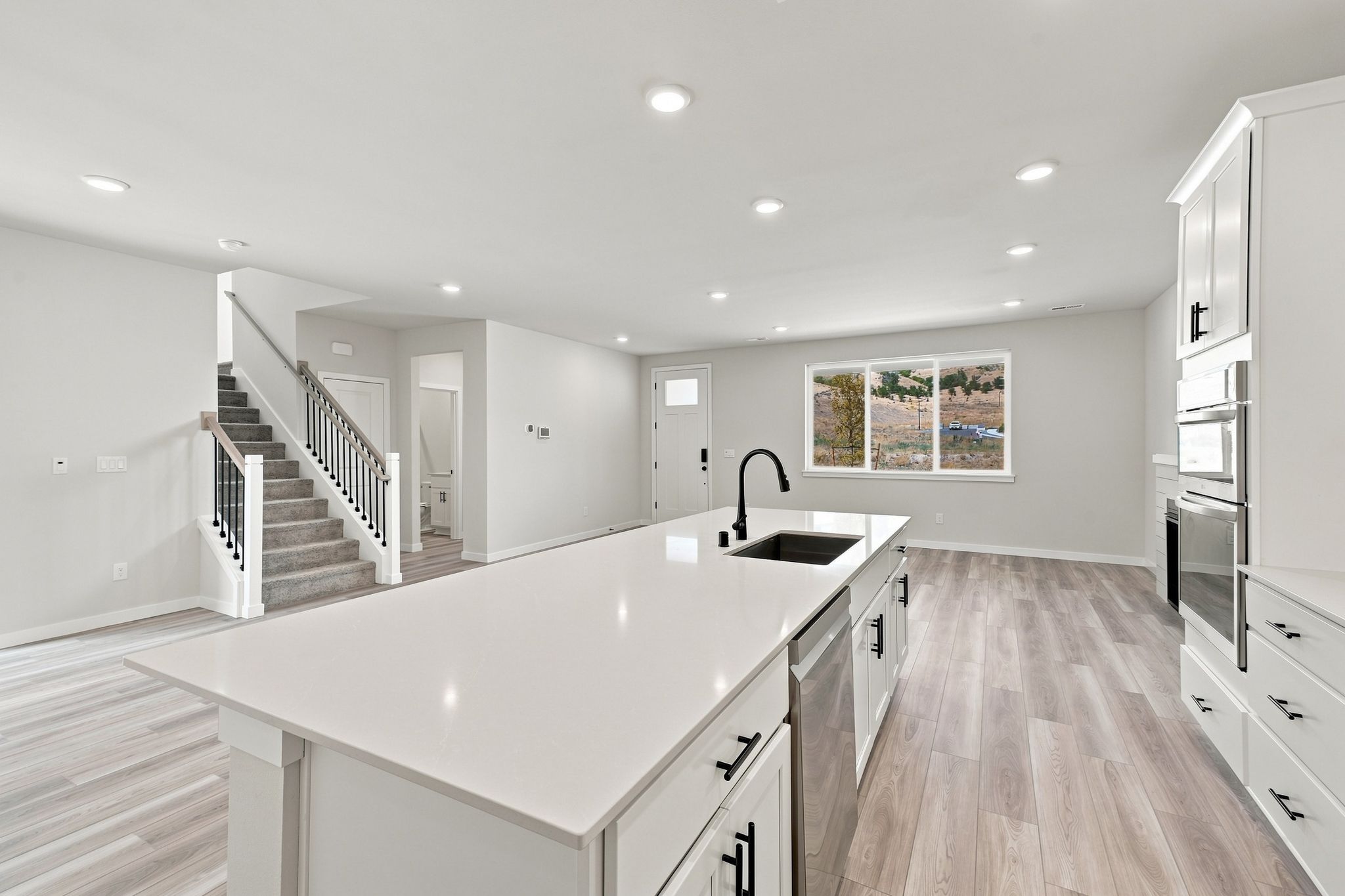 A kitchen with a large white counter.