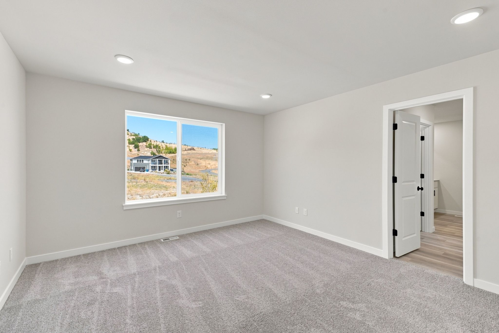 A room with a window and a door.