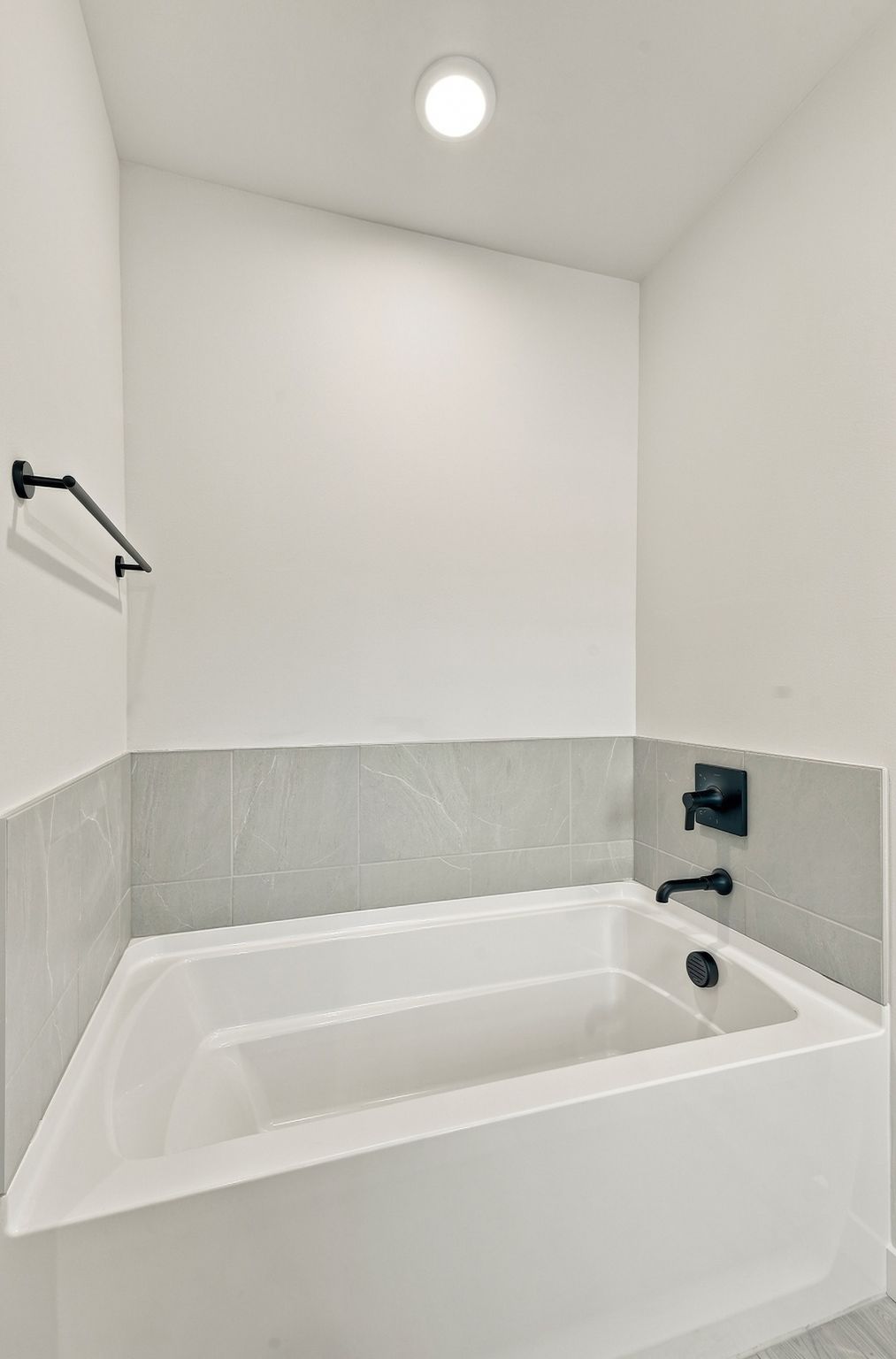 A bathtub in a bathroom.