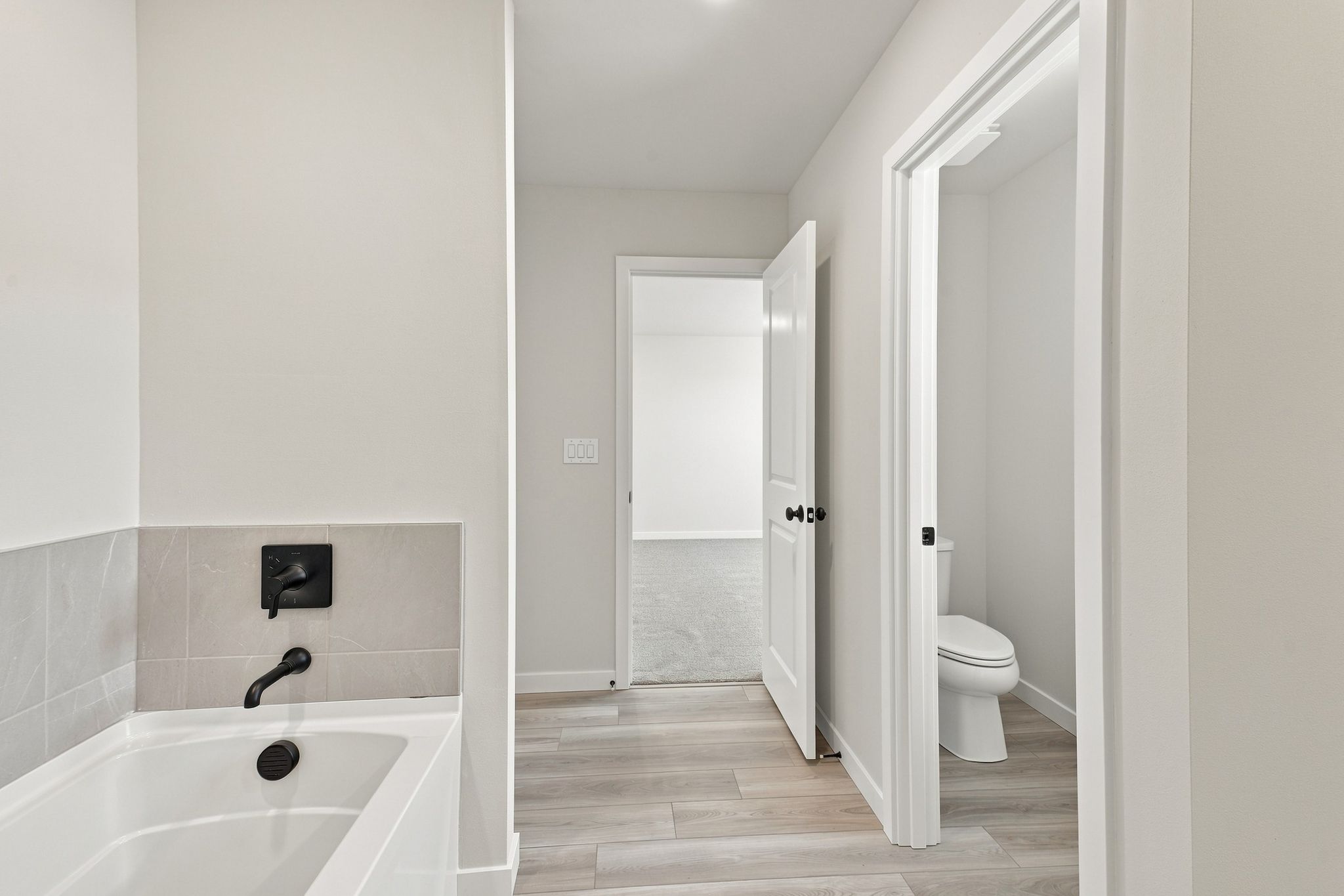 A bathroom with a tub toilet and sink.