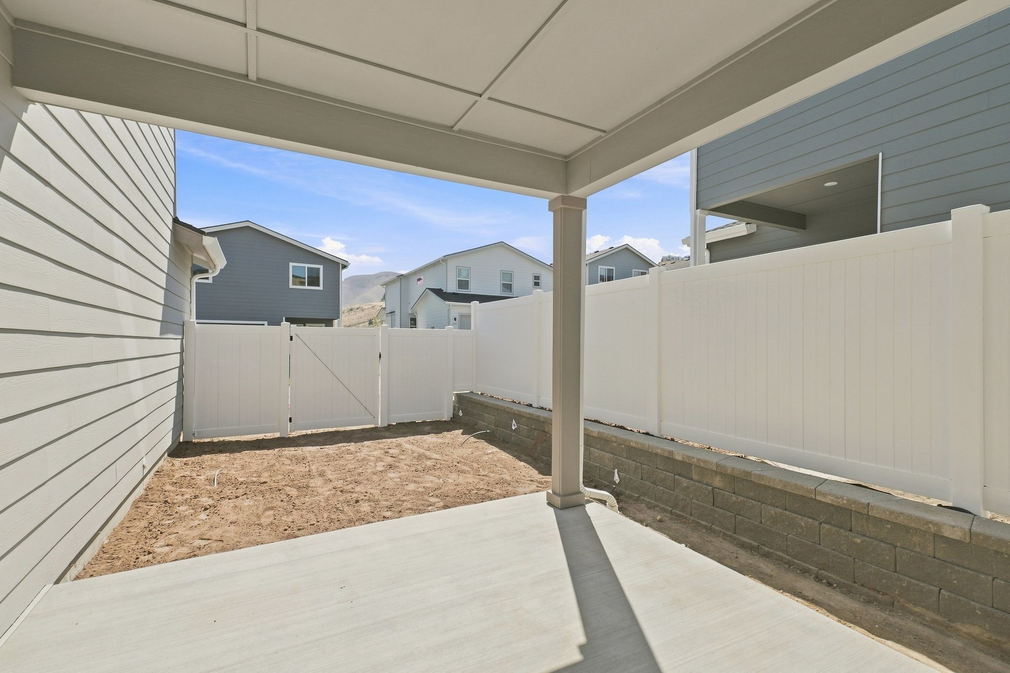 A white fence and a building.