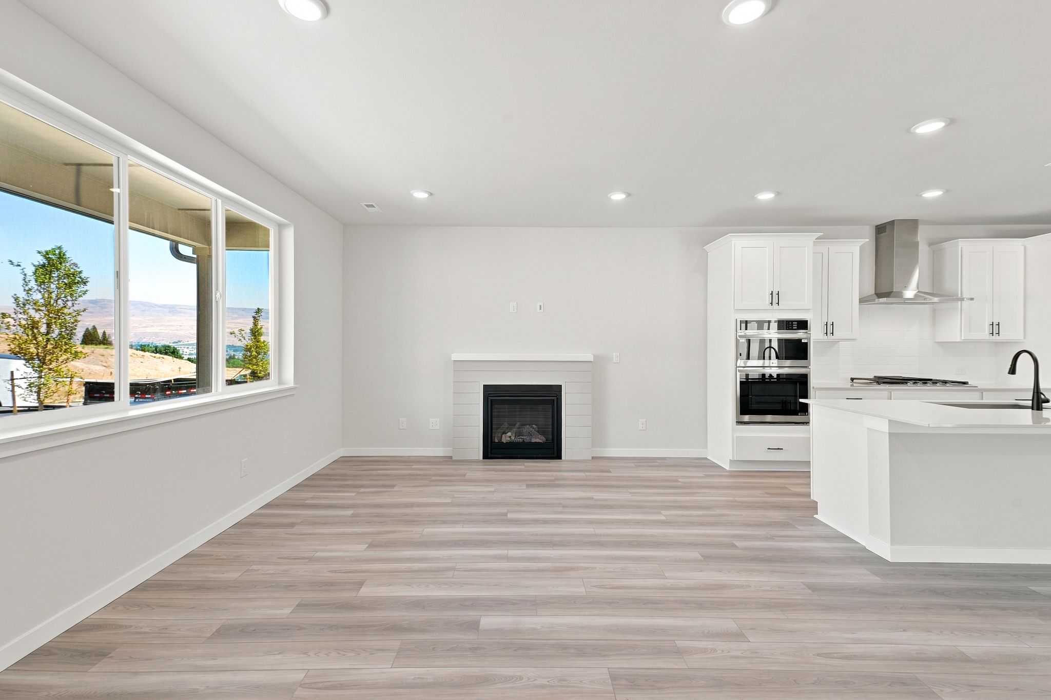 A kitchen with white cabinets.