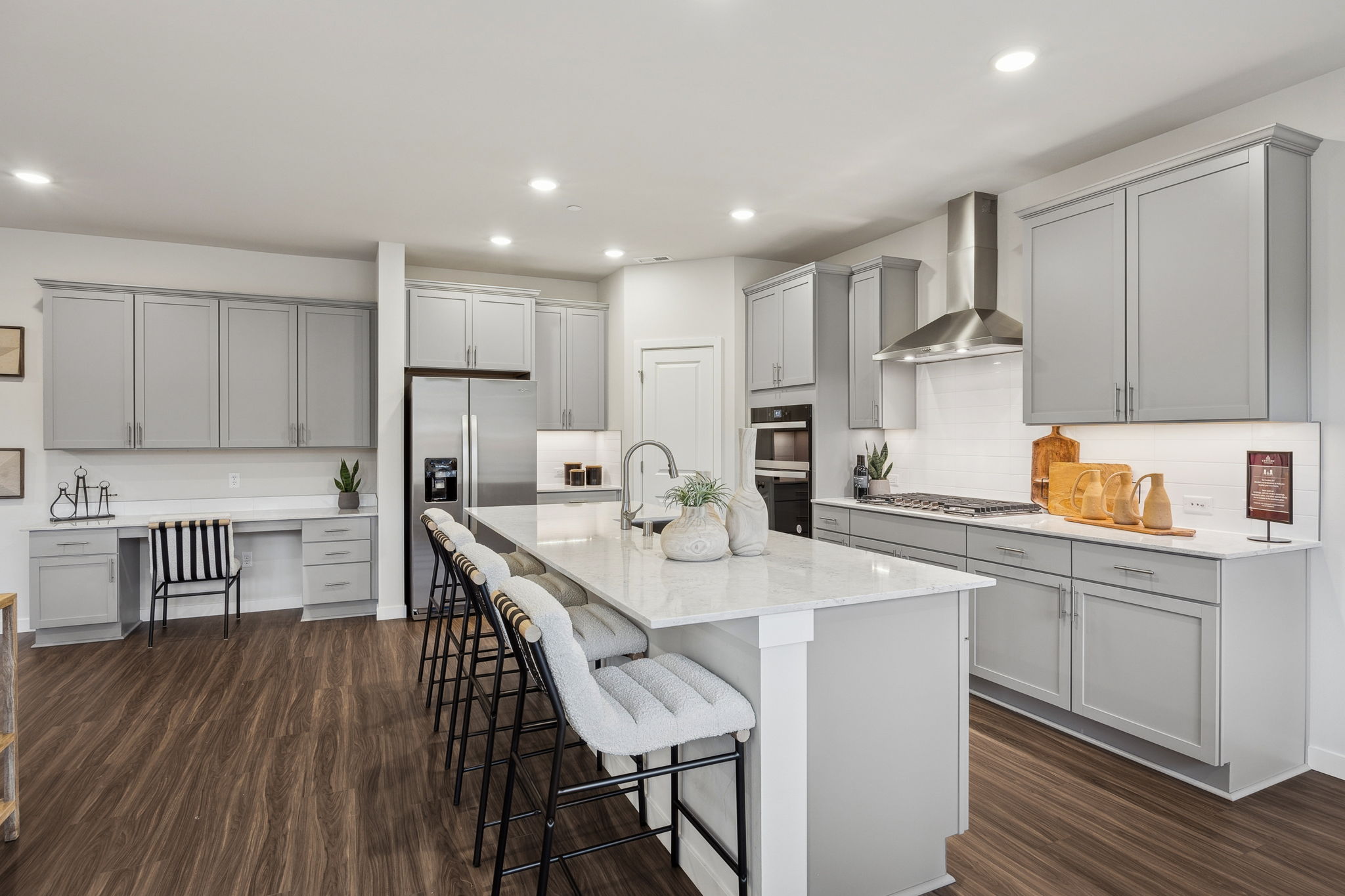 A kitchen with white cabinets.
