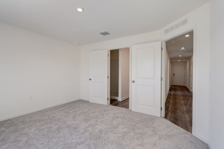 A hallway with white doors.