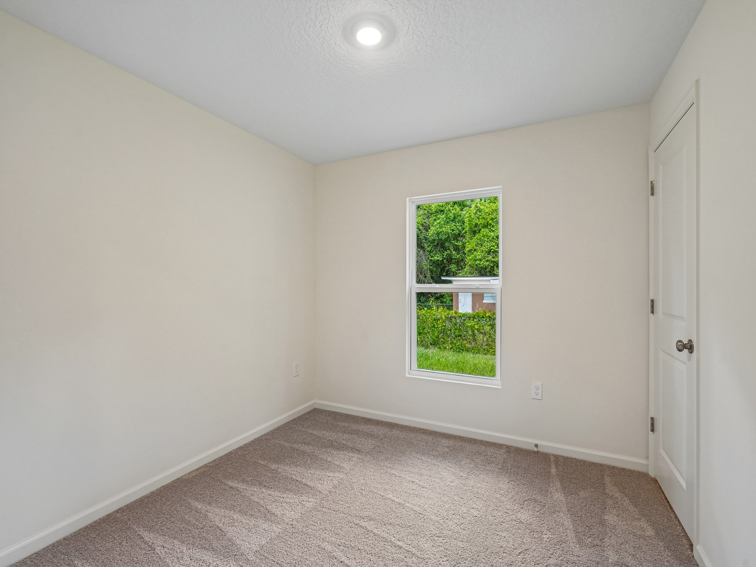 A room with a window and a door.