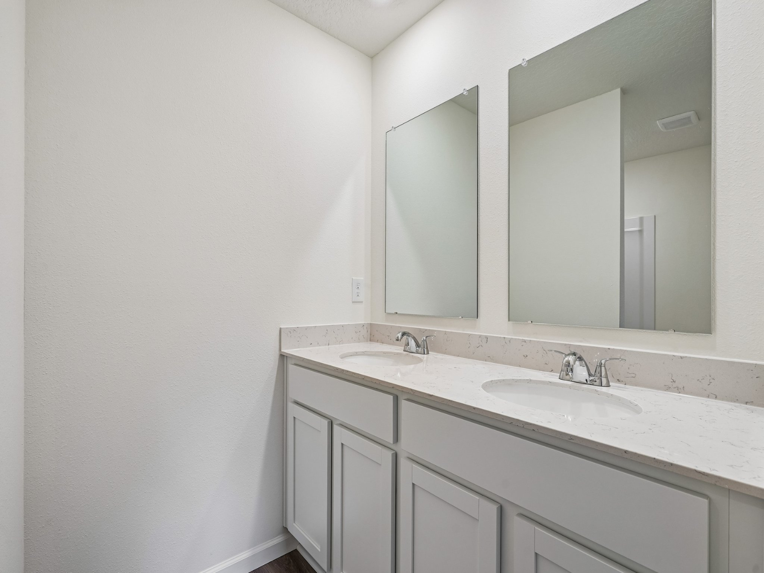 A bathroom with a large mirror.