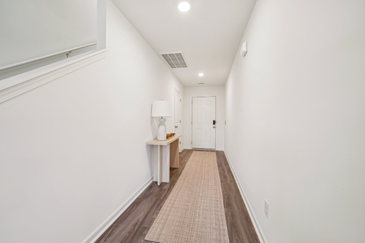 A hallway with white walls.