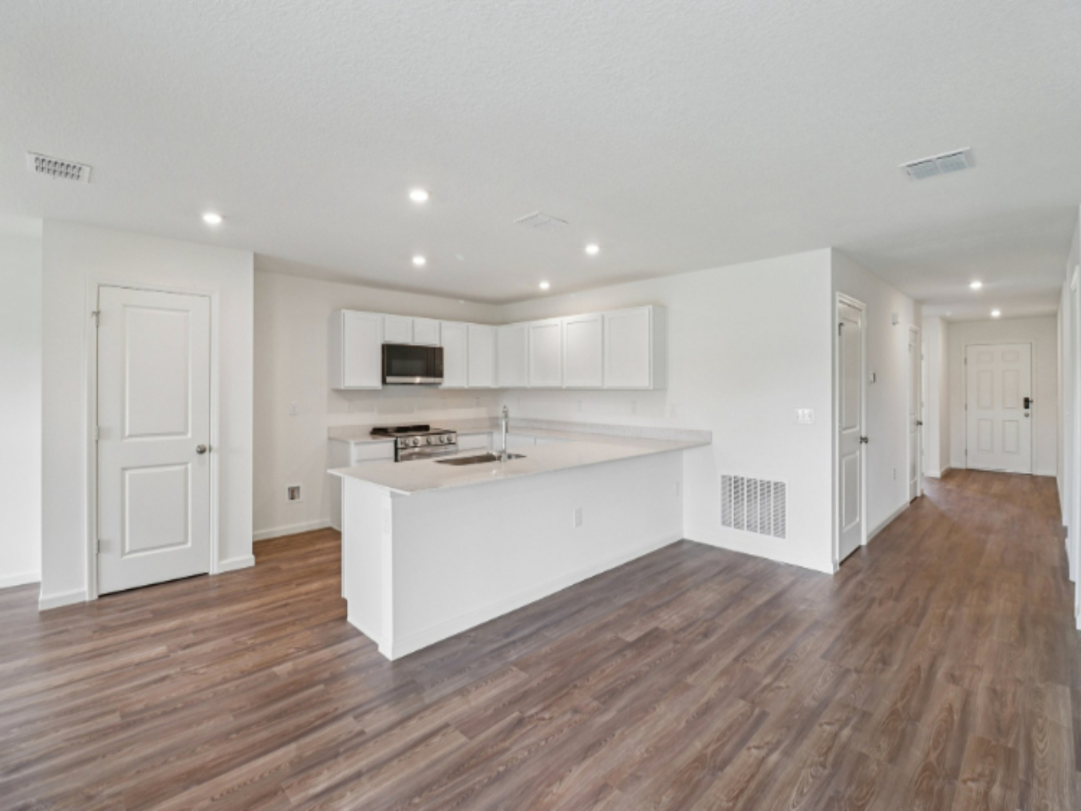 A kitchen with white cabinets.