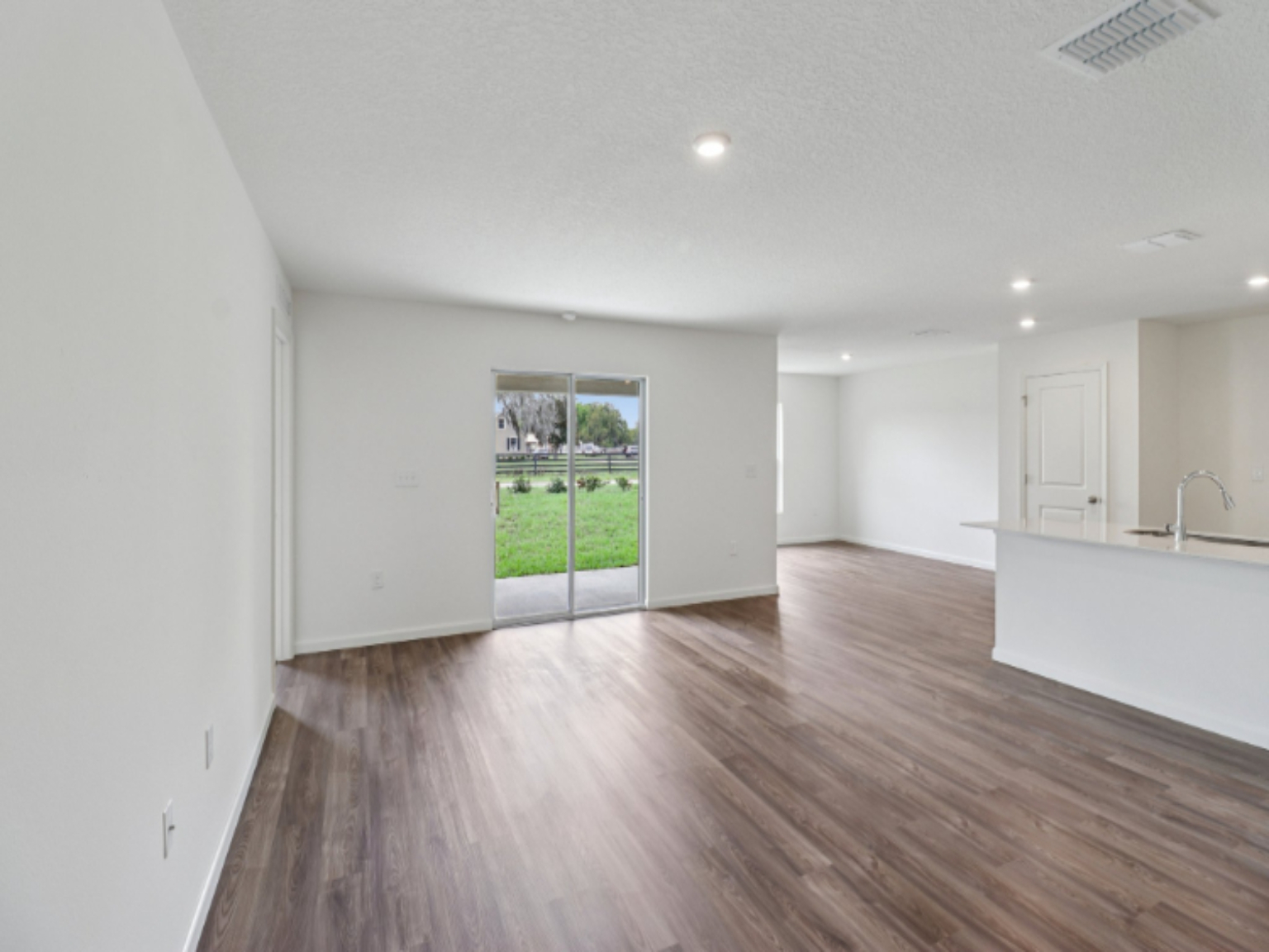 A room with white walls and a wood floor.