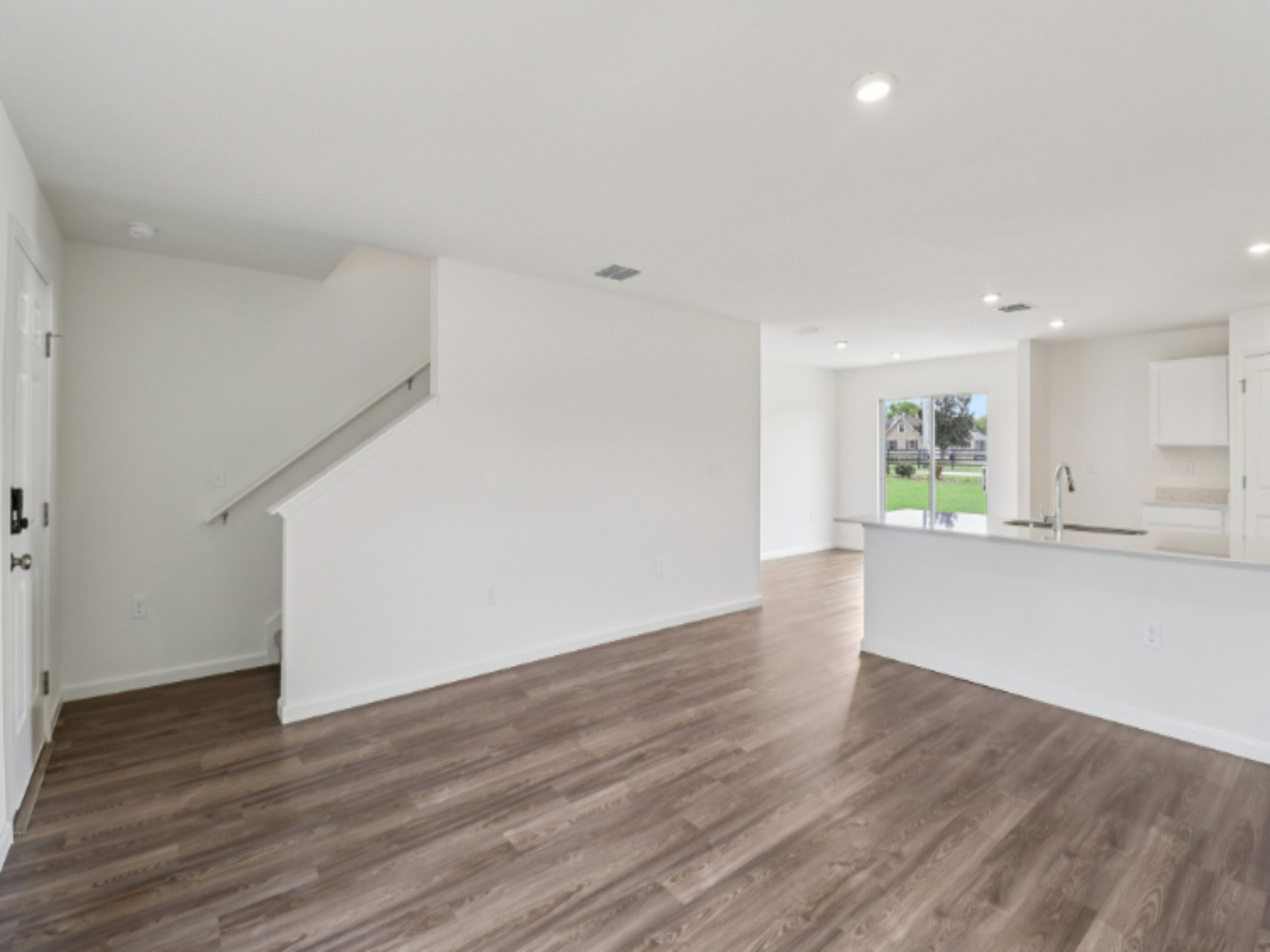 A room with white walls and a wood floor.