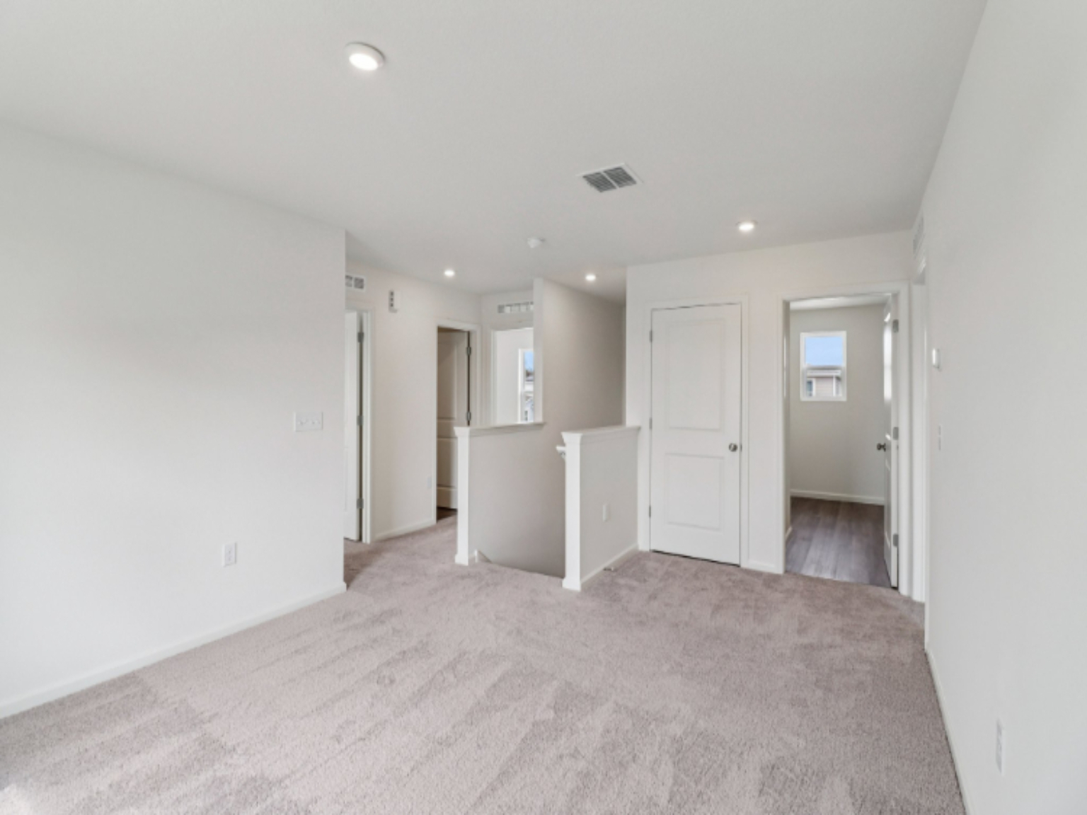 A hallway with white doors.