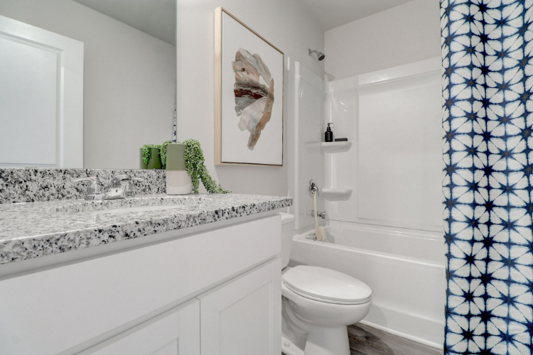 A bathroom with a marble countertop.