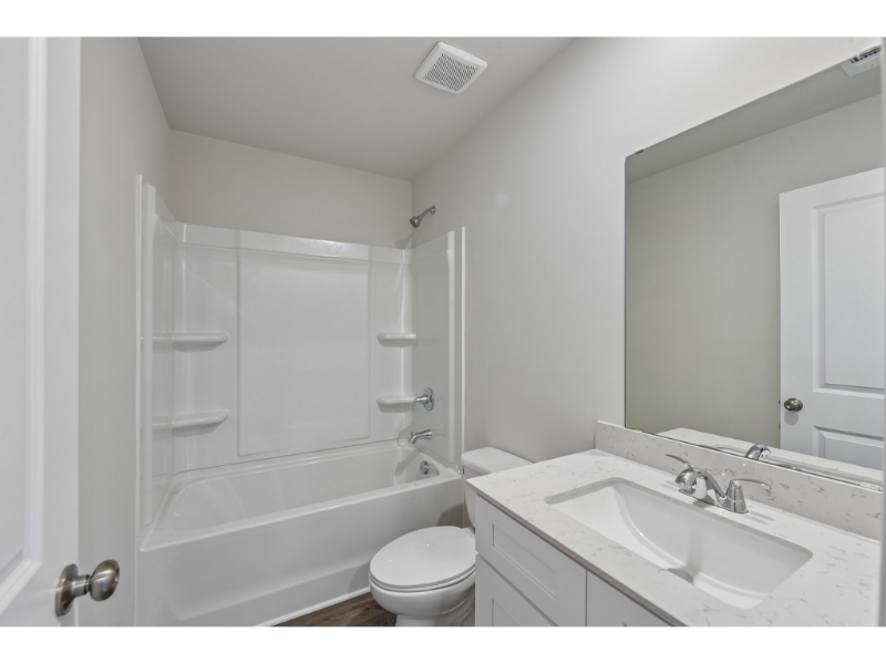 A bathroom with a sink toilet and bathtub.